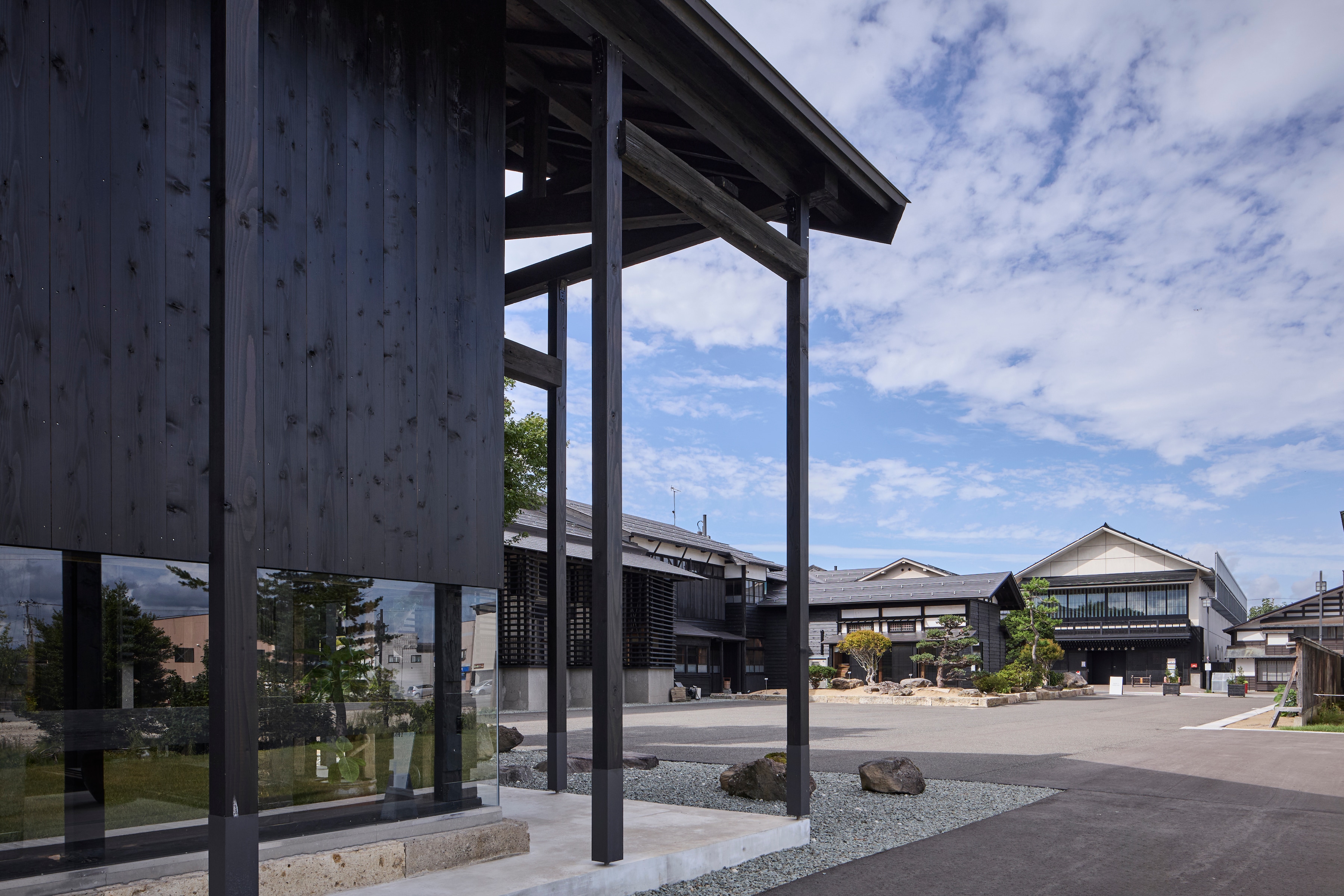 Facade | The lounge building, a renovated rice storehouse, overlooks the outdoor plaza and main house.