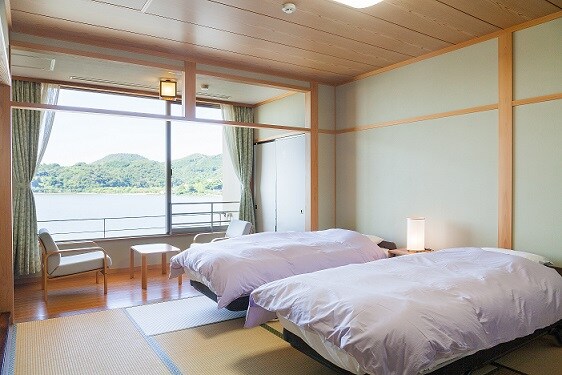Two beds in a Japanese-style room overlooking the lake