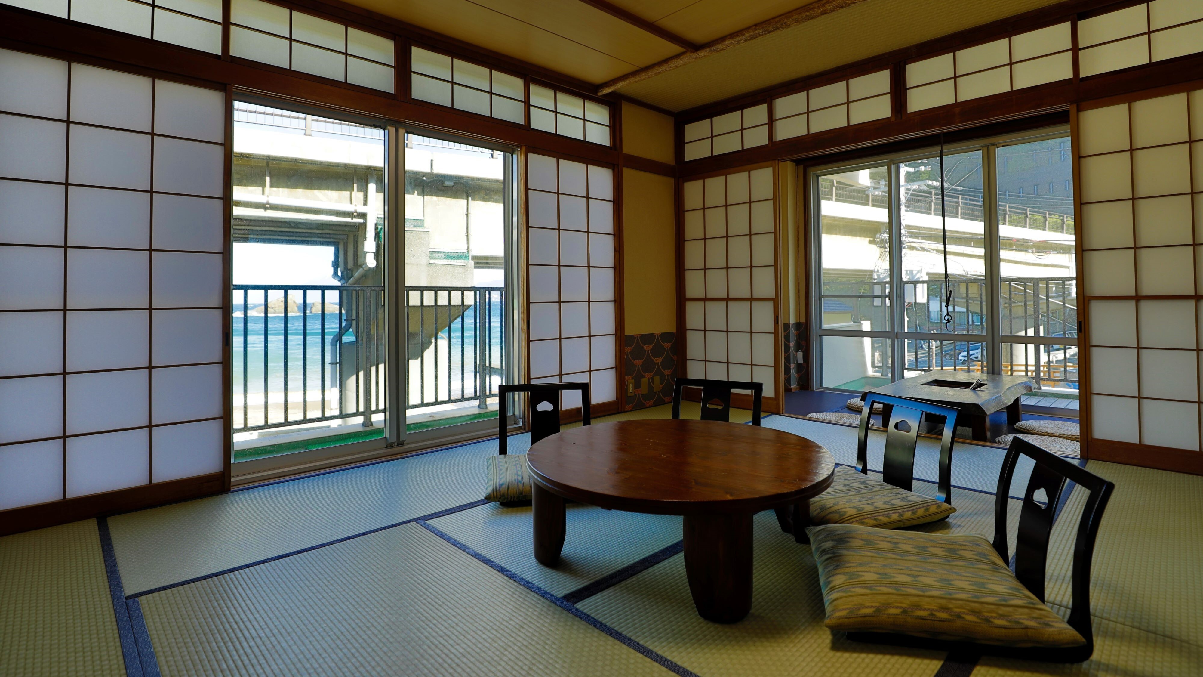 Ocean-facing 10-tatami Japanese-style room with an open-air bath. You can see the beautiful ocean over the elevated railway.