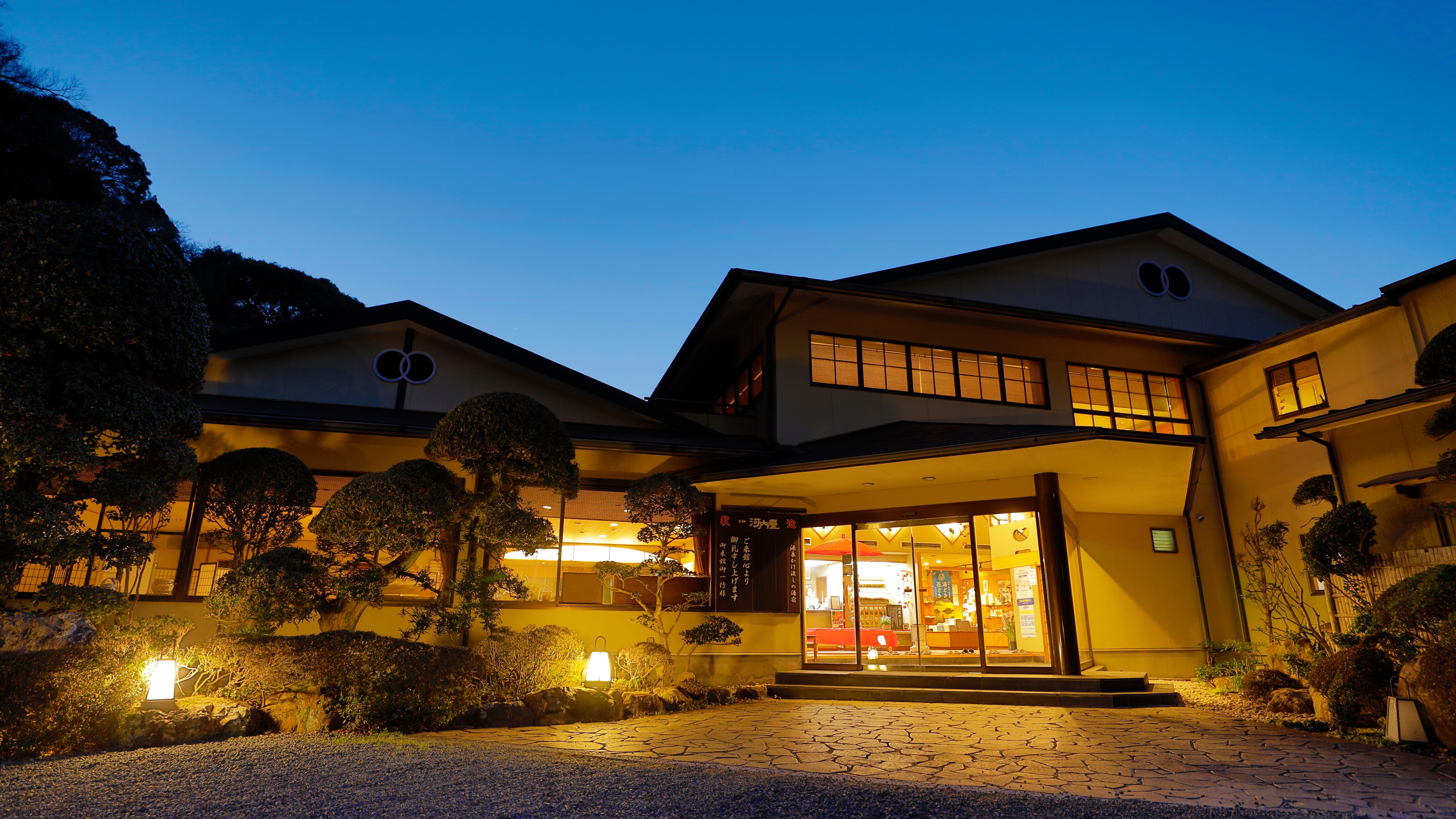 The light from inside the building leaks out and pours light into the pitch-black area.