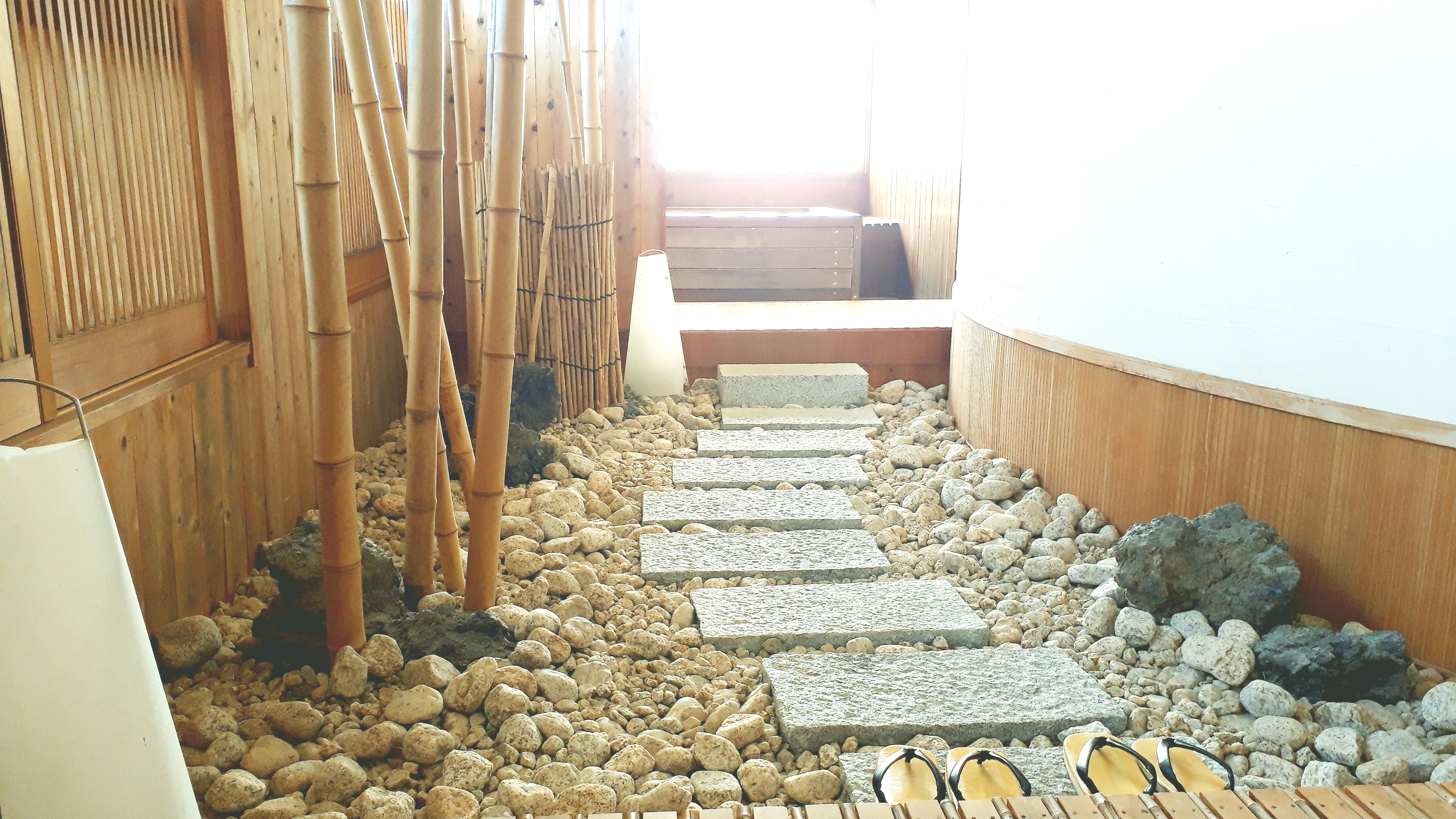 Japanese-style room with open-air bath with garden