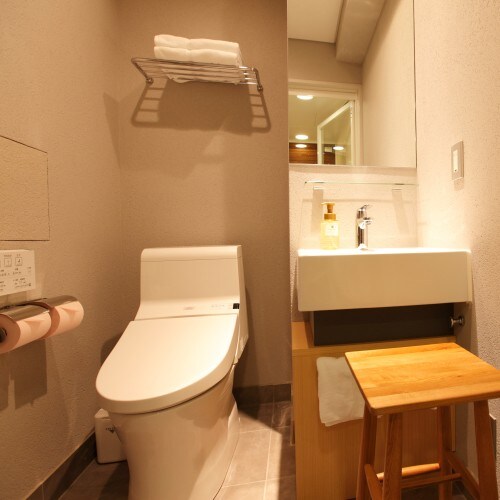 The powder room in the Amanek double room is separate from the bath. A stool is also provided.