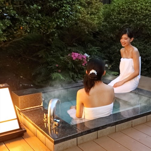The open-air bath facing the garden is fed directly from the source