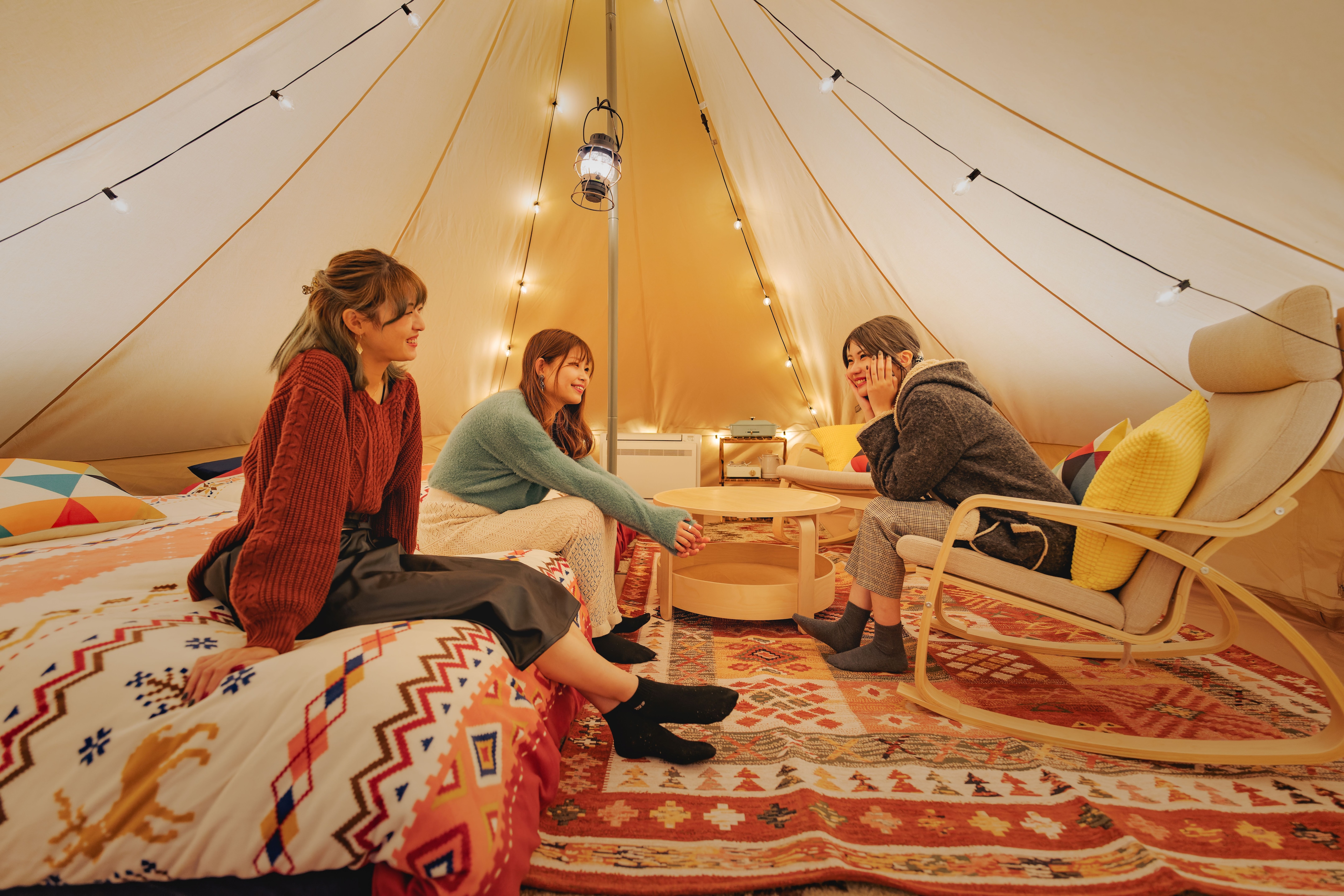 Girls talk in a tent