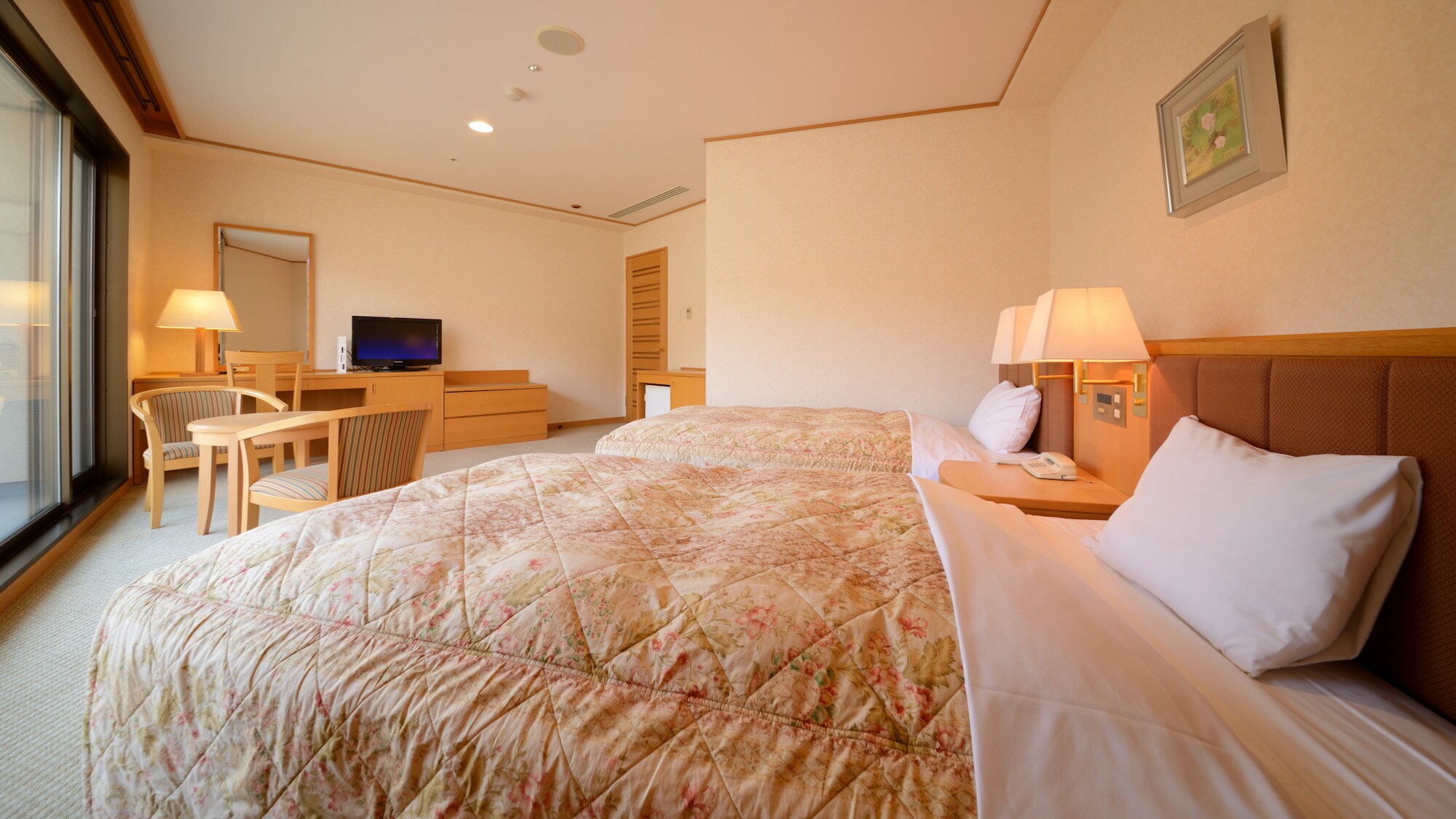 Western-style room. The natural light coming in through the large windows is perfect for a refreshing morning wake-up.