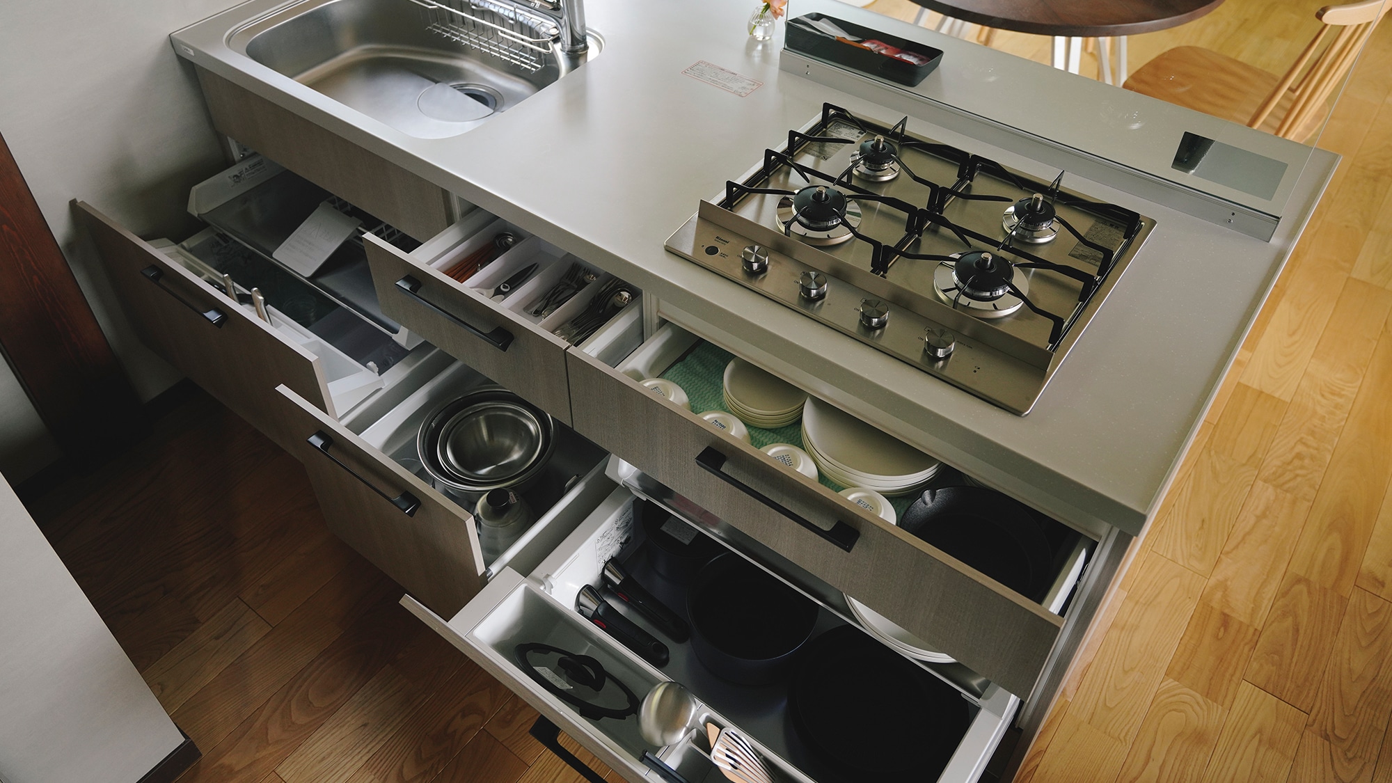 The kitchen is fully equipped with dishes and cutlery.
