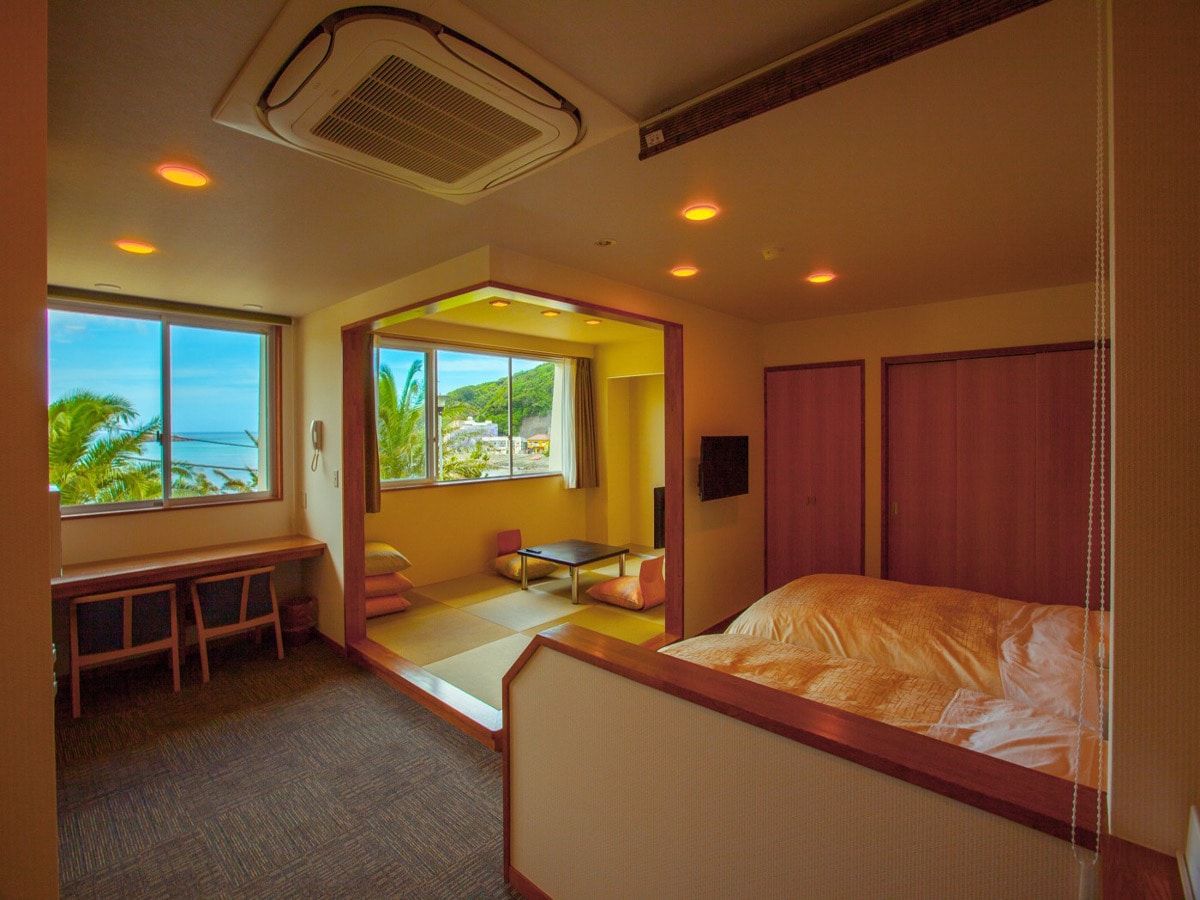 A relaxing Japanese-Western style room with ocean view and a semi-open-air bath