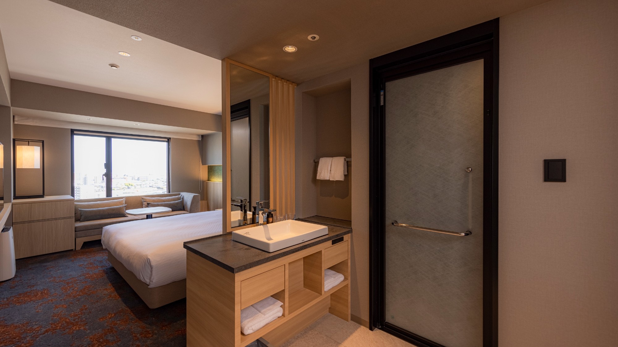 [Moderate Double] A queen-size bed with a separate shower booth.