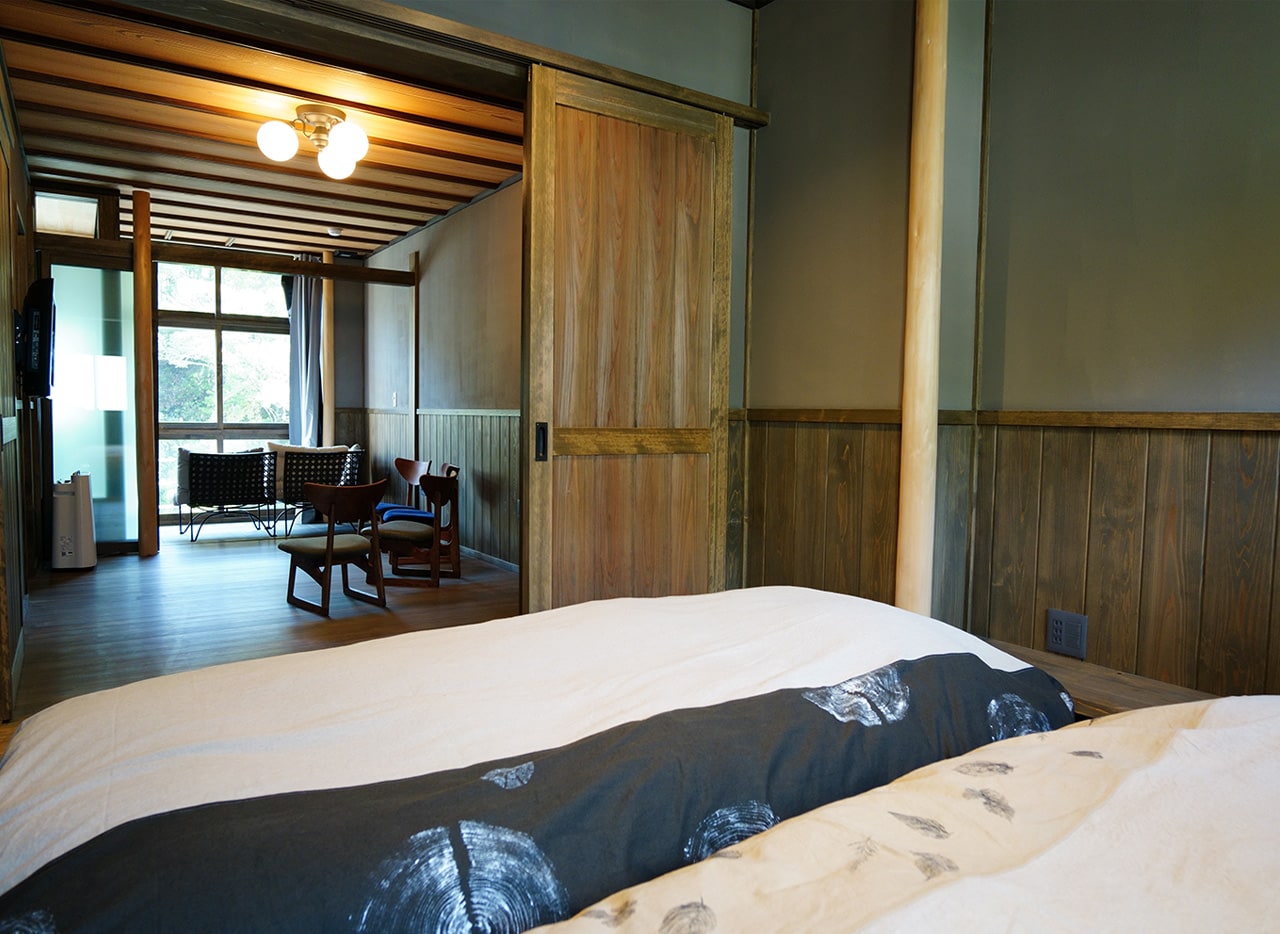 Guest room with hot spring overlooking the mountain stream (living + twin) View from the bedroom