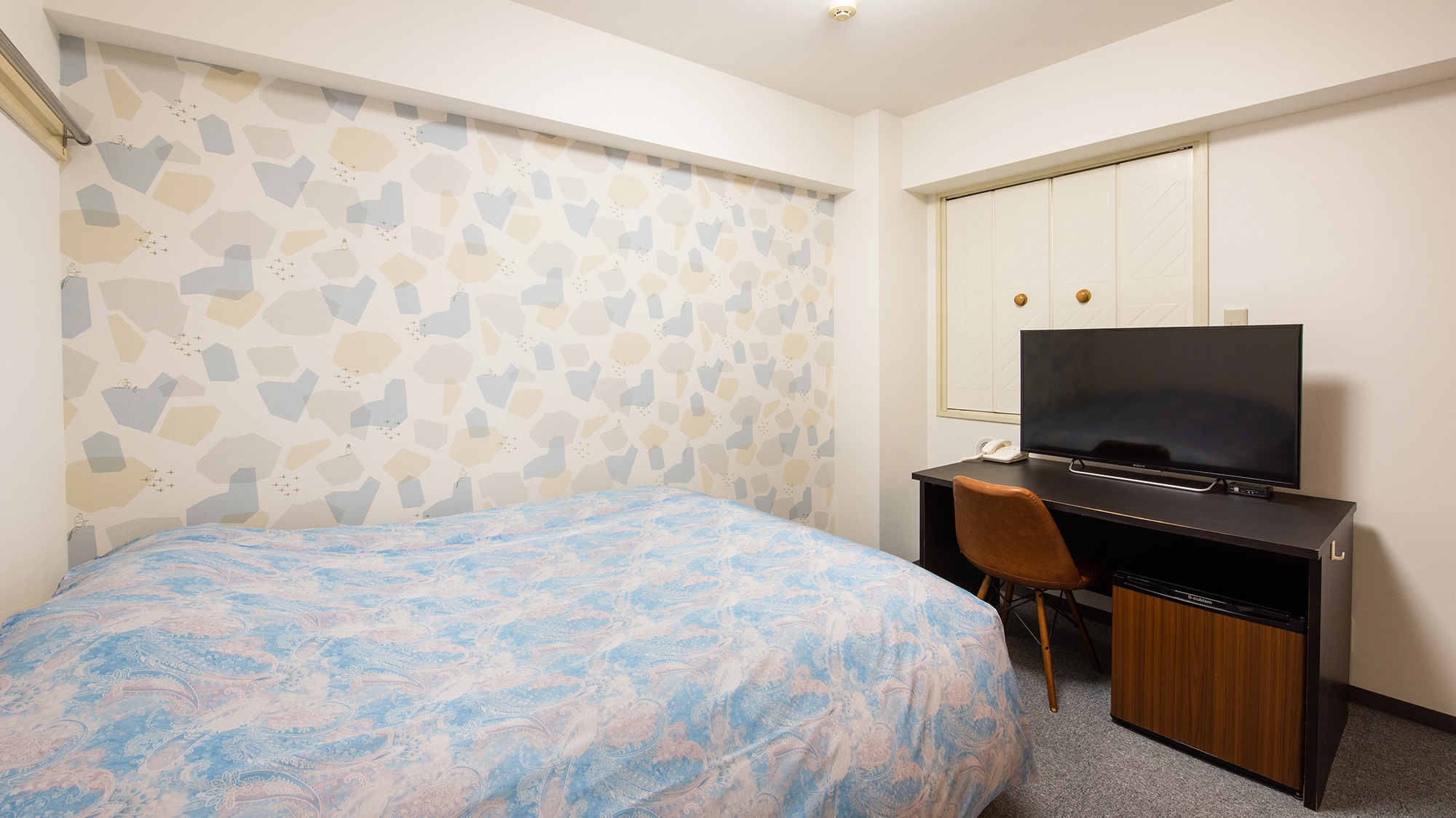 Separate bathroom and toilet. Cute wallpaper.