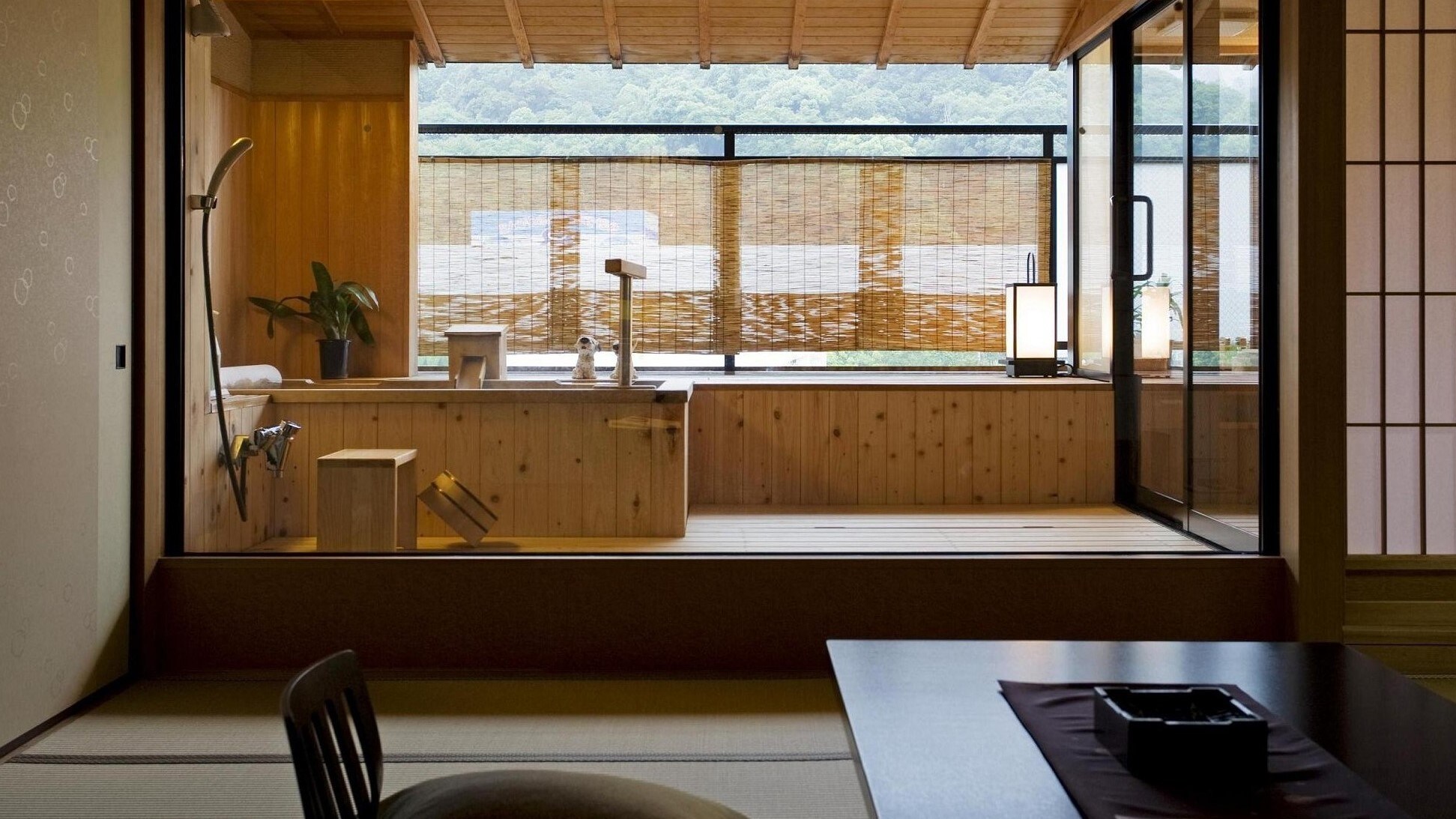 A guest room with an open-air bath at Sansuikan, a cypress-style bath