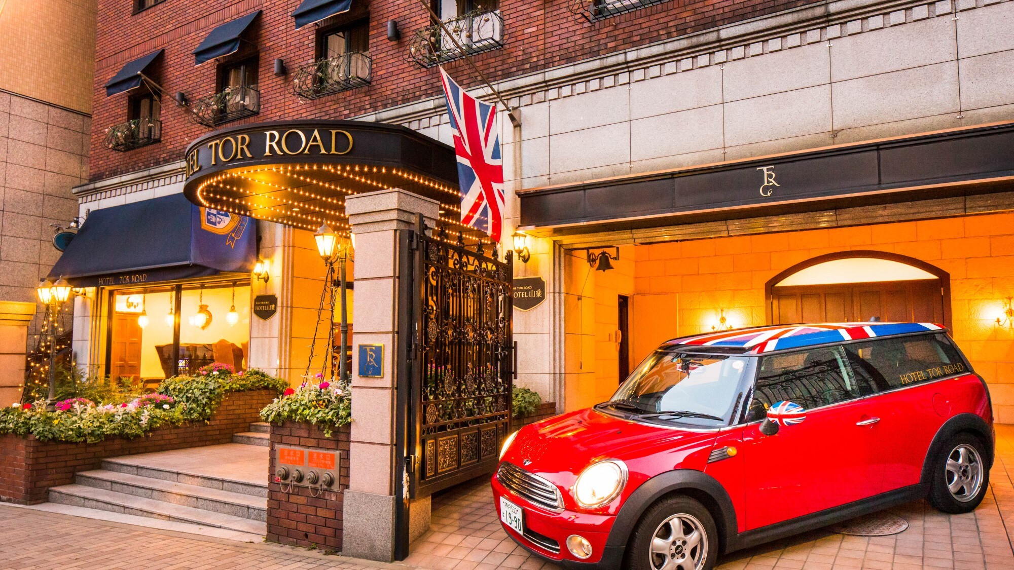 A bright red Union Jack mini cooper welcomes you