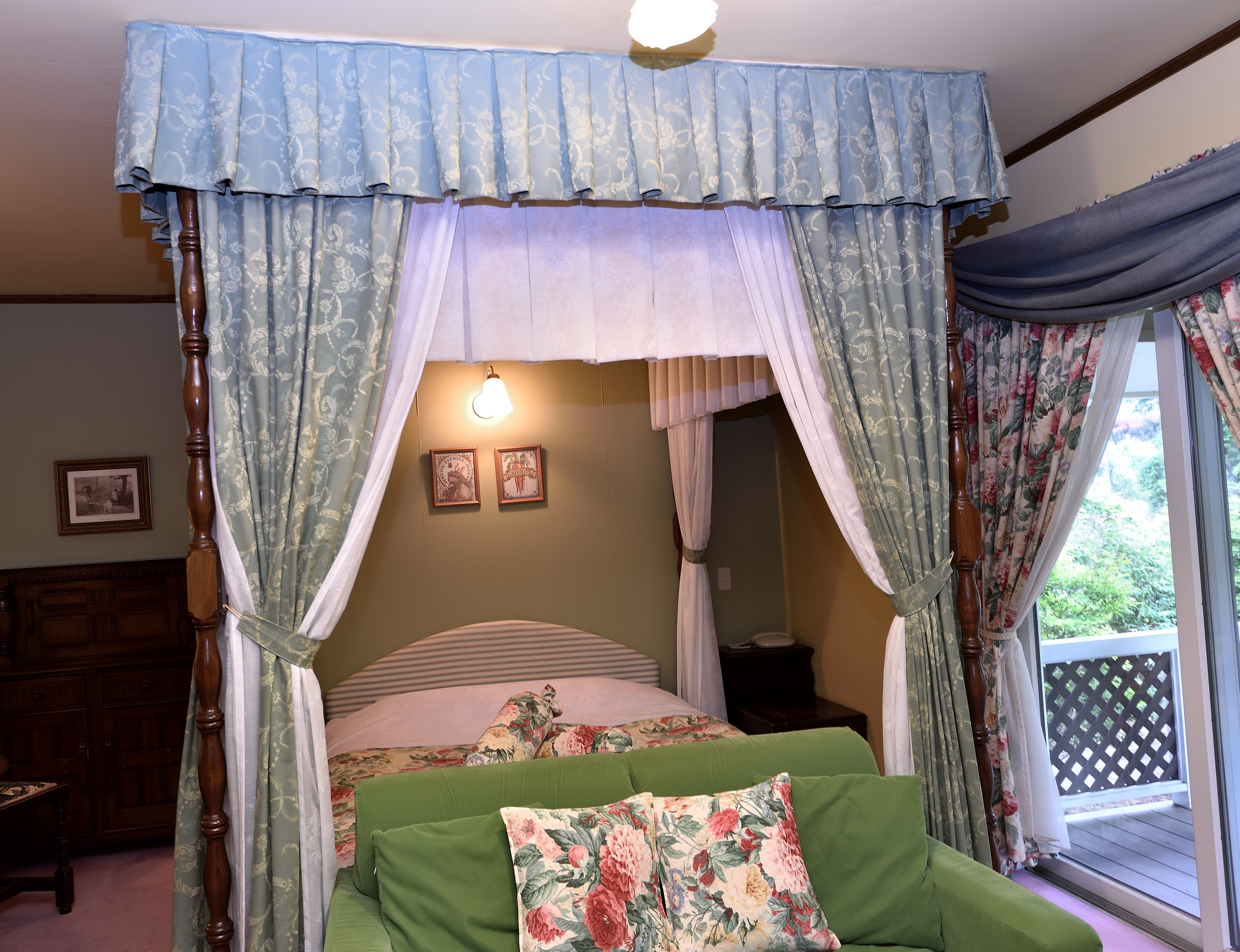 This is a queen-size double bed with a canopy in room 112.