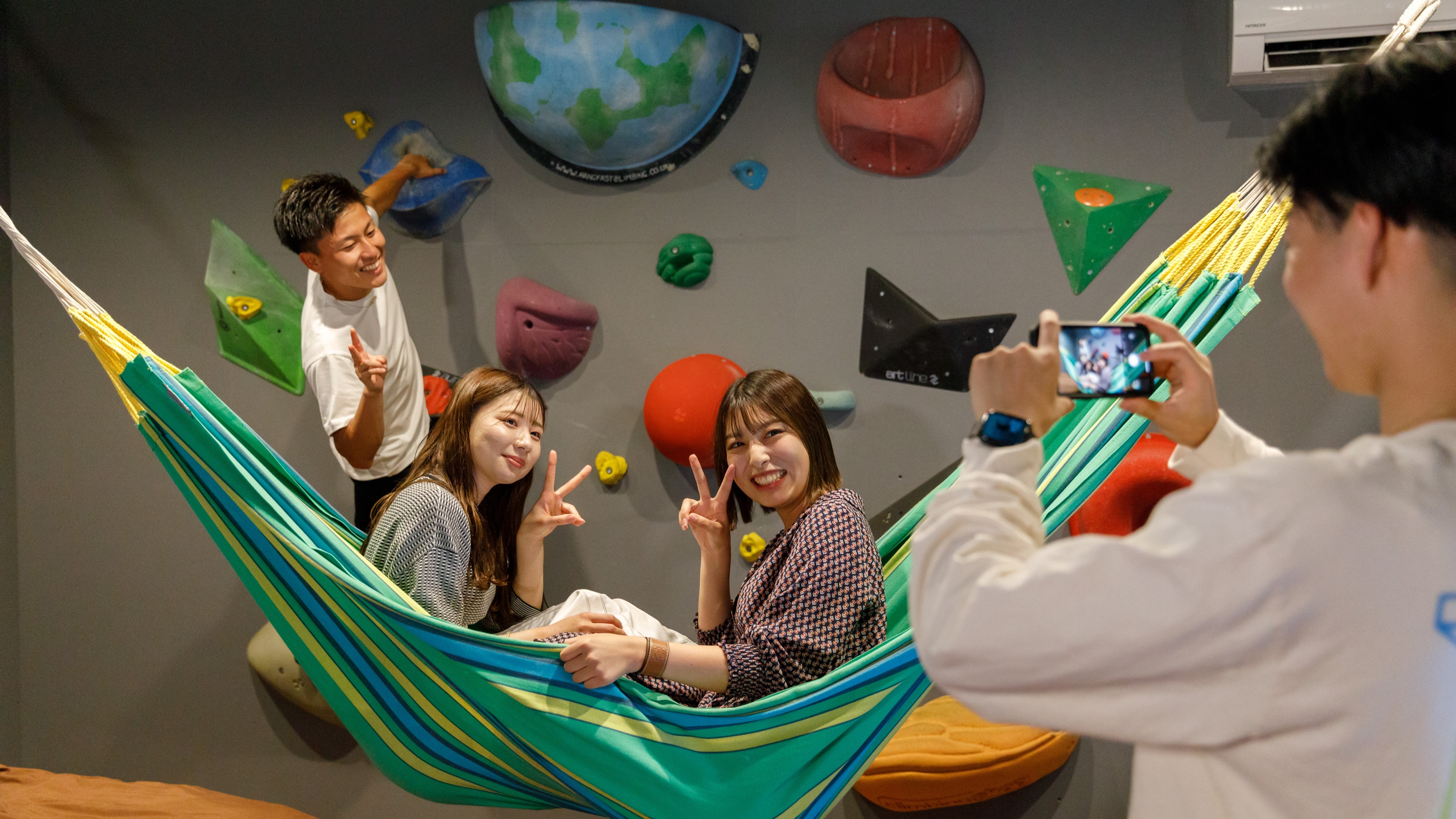Commemorative photo taken in a hammock and on the bouldering wall