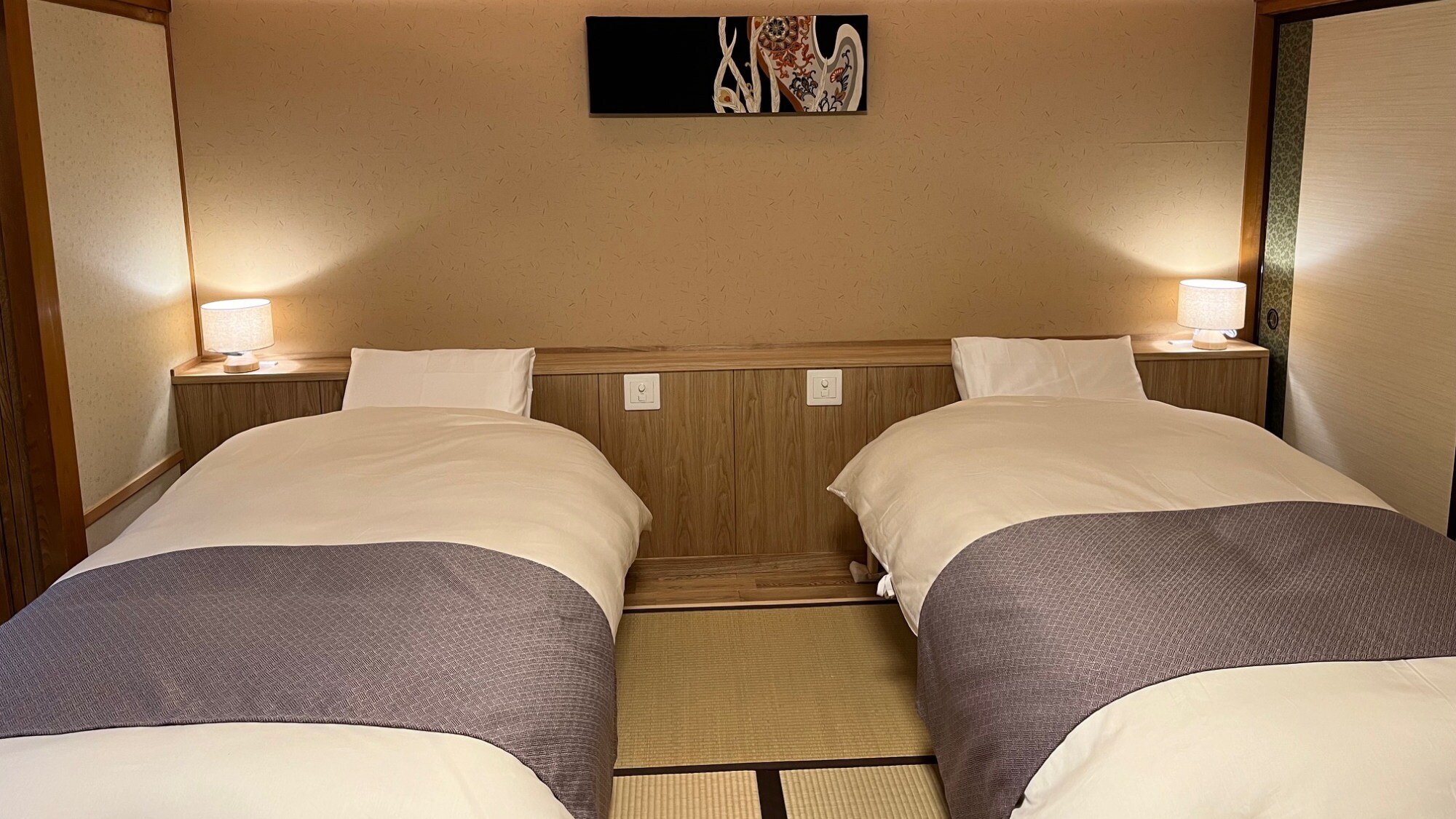 A Japanese-style twin room with 8 tatami mats and a sunken kotatsu table overlooking Mt. Tanigawa (example)