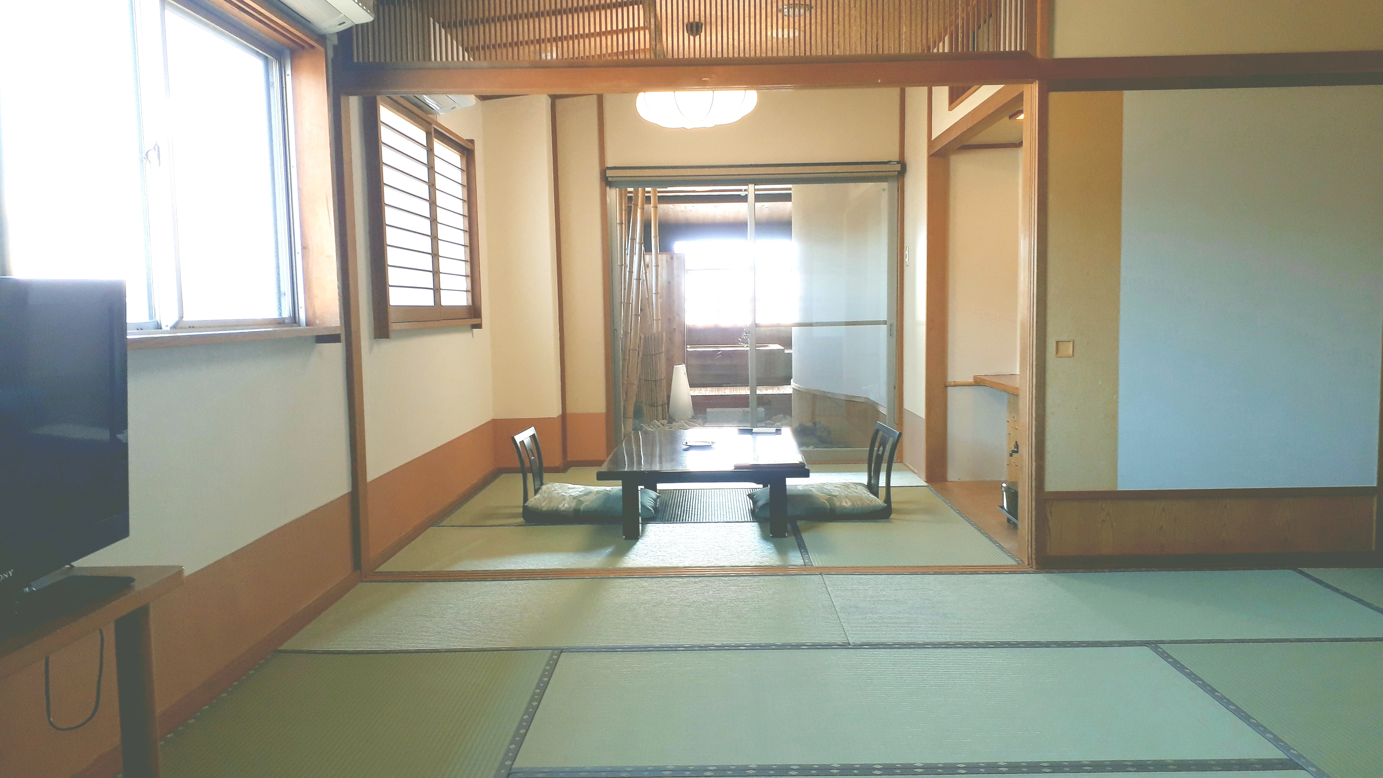 Japanese-style room with open-air bath with garden