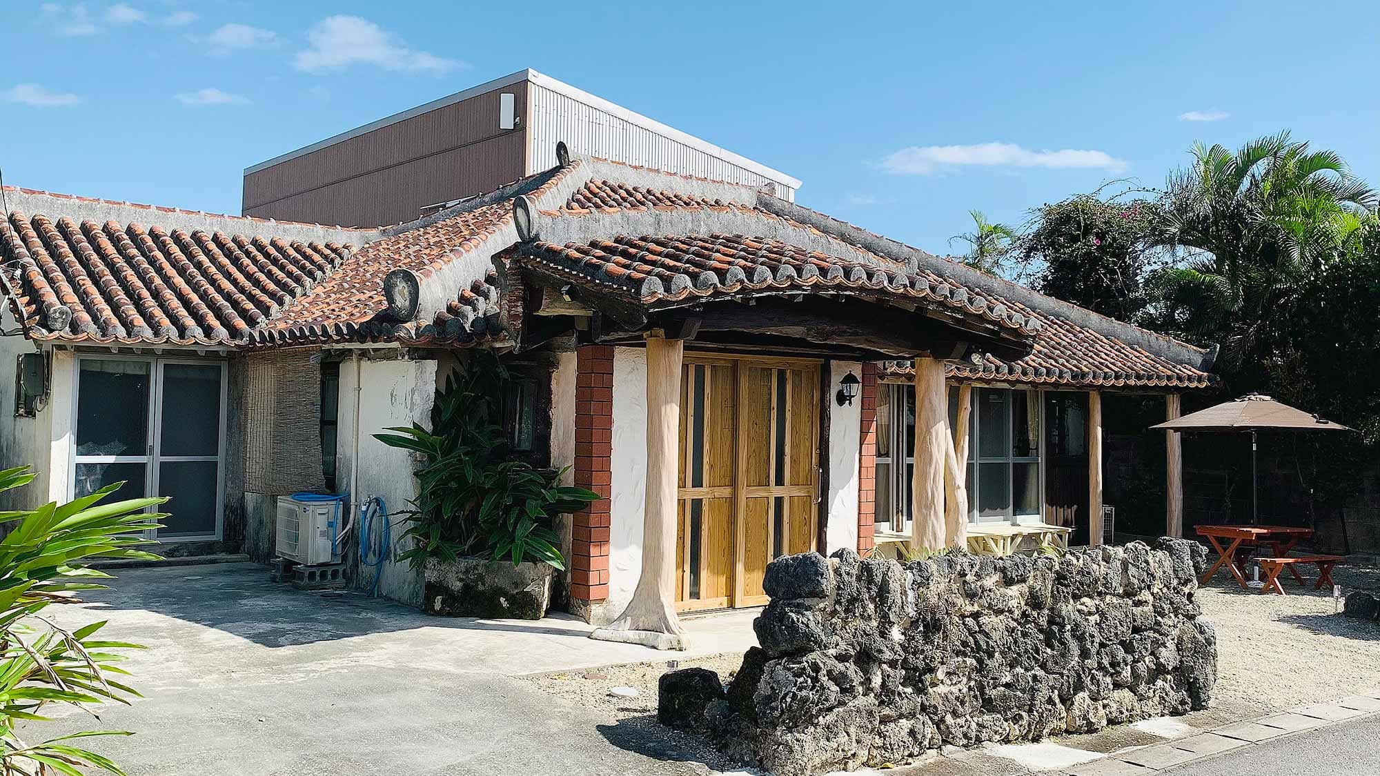 ・ Exterior of "Main Building": An old folk house featuring a traditional red tile roof