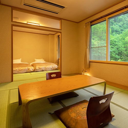 ■18 tatami Japanese-style room■The low bed provides a more comfortable sleep than a futon. The view of the forest from the large window is relaxing.