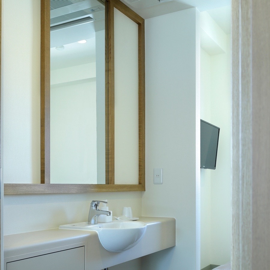 The washroom facilities in the single rooms are compact but clean.