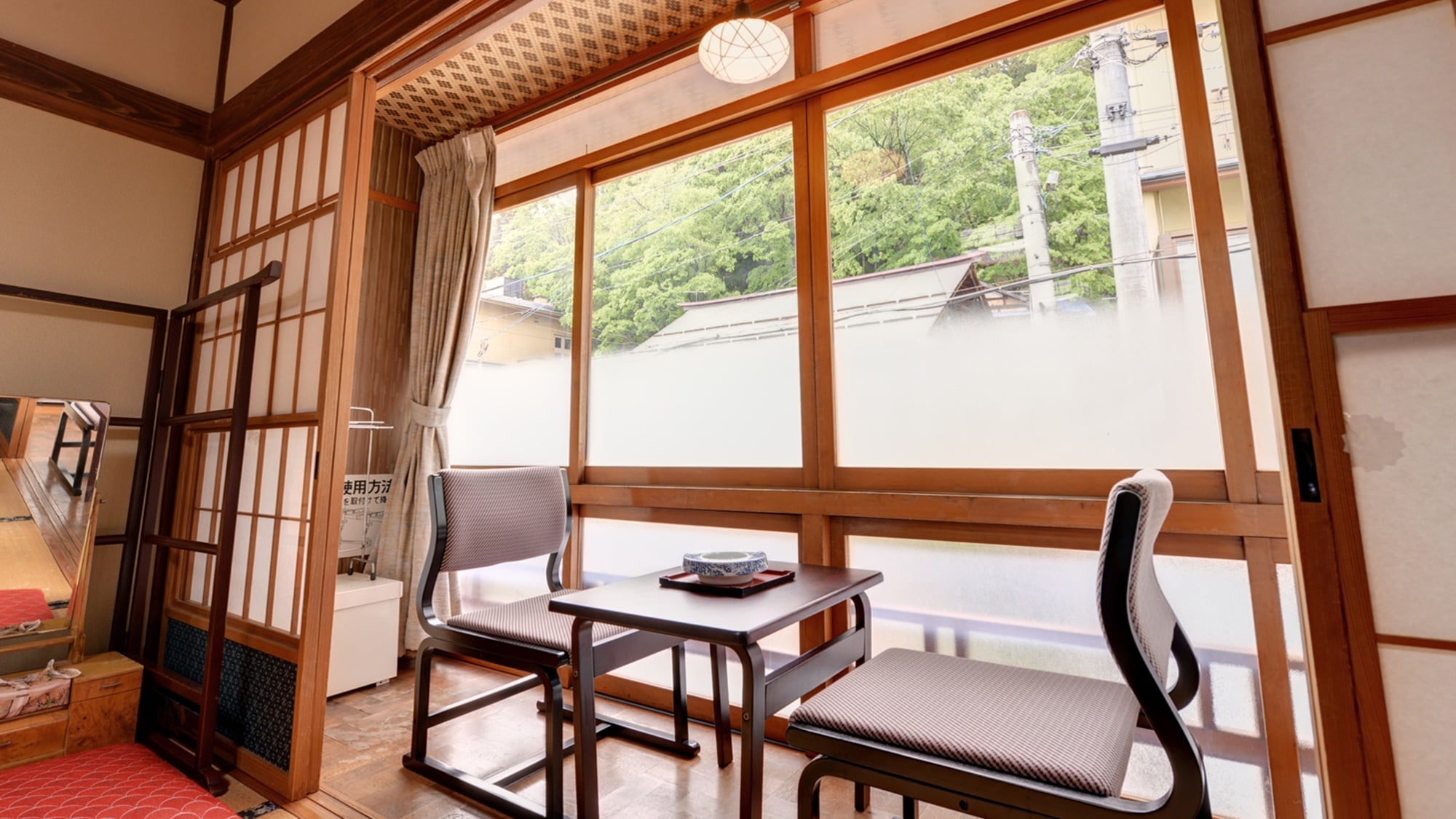 *12 tatami Japanese-style room (example of a guest room)/Sit on a chair by the window and enjoy a panoramic view of the historic hot spring town of Shibu with steam rising from the hot springs.