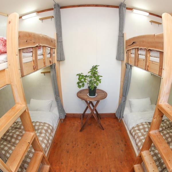 Gender mixed dormitory. Relax in the original wooden bed.