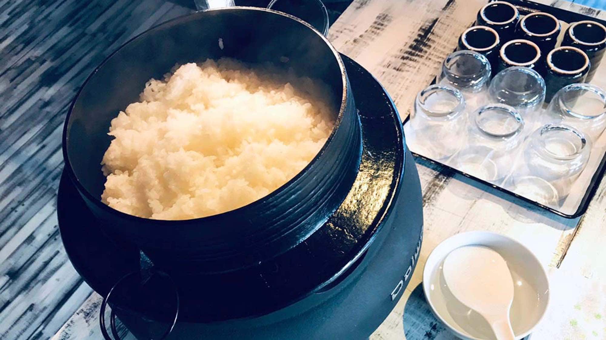 Breakfast is shiny white rice cooked in a stove
