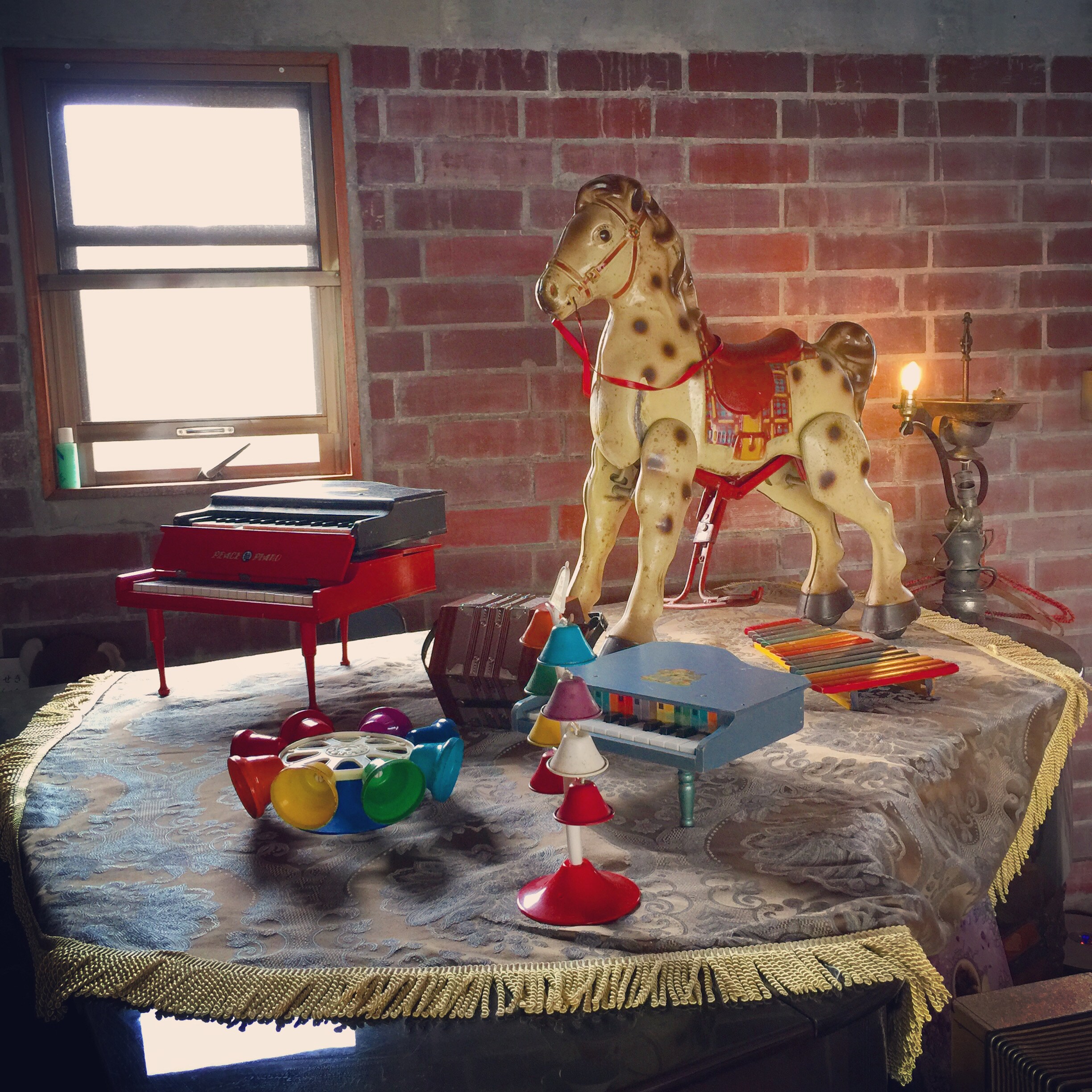 There are grand pianos, numerous toy pianos, and musical instruments. (Grand piano cottage)