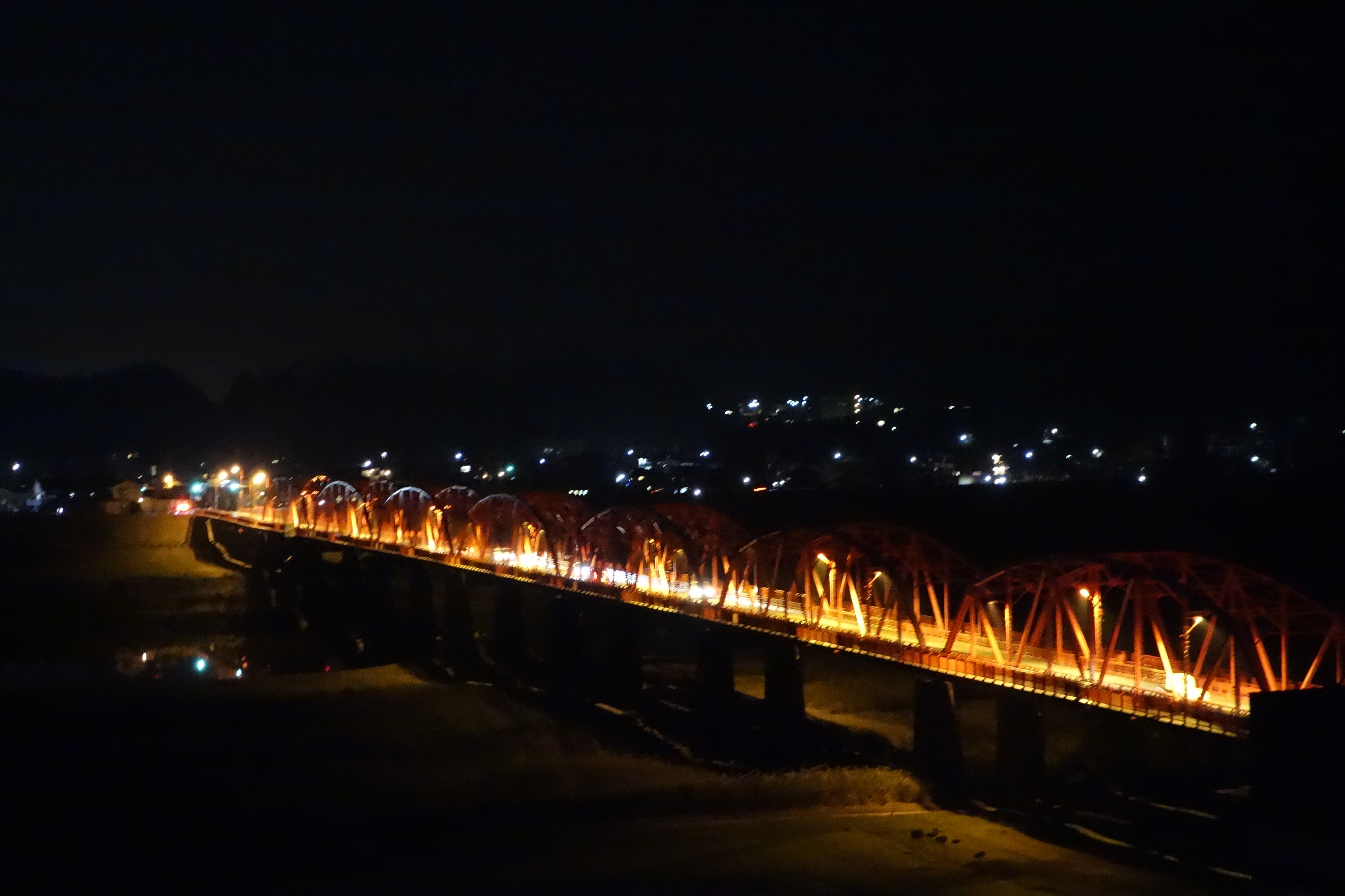Red iron bridge at night