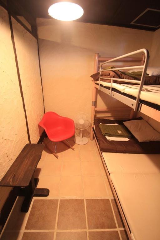 Simple private room, Okinawa plaster on the wall, ital tile, rocking chair of Eames