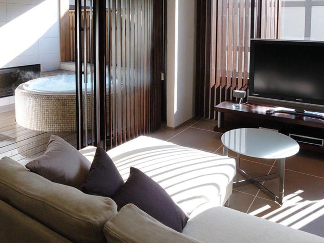Western-style room with hot spring jacuzzi and bedrock bath