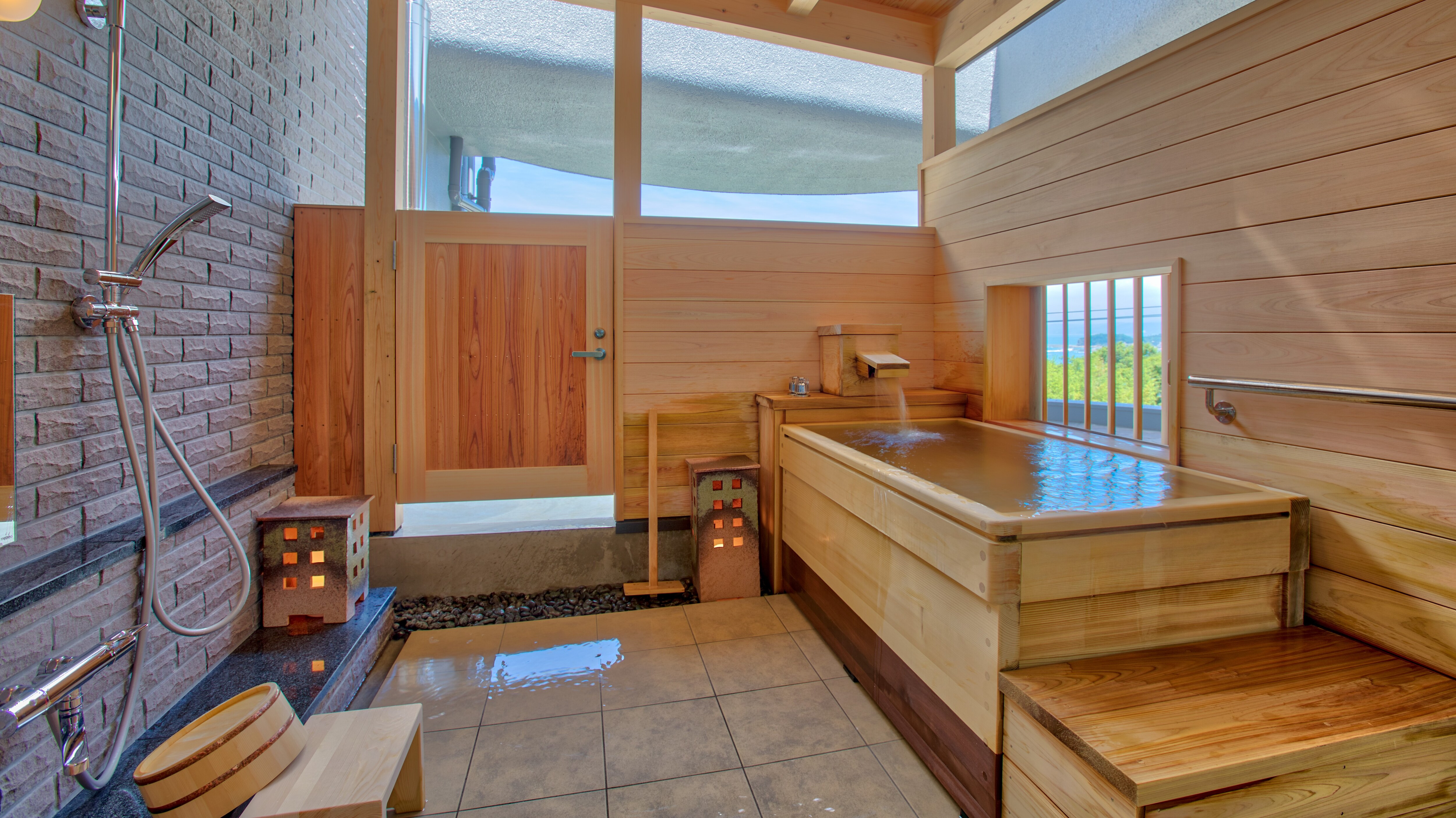 [Example of an open-air bath in a guest room] The rooms with Koya-maki baths are separate Japanese-style and Western-style rooms.