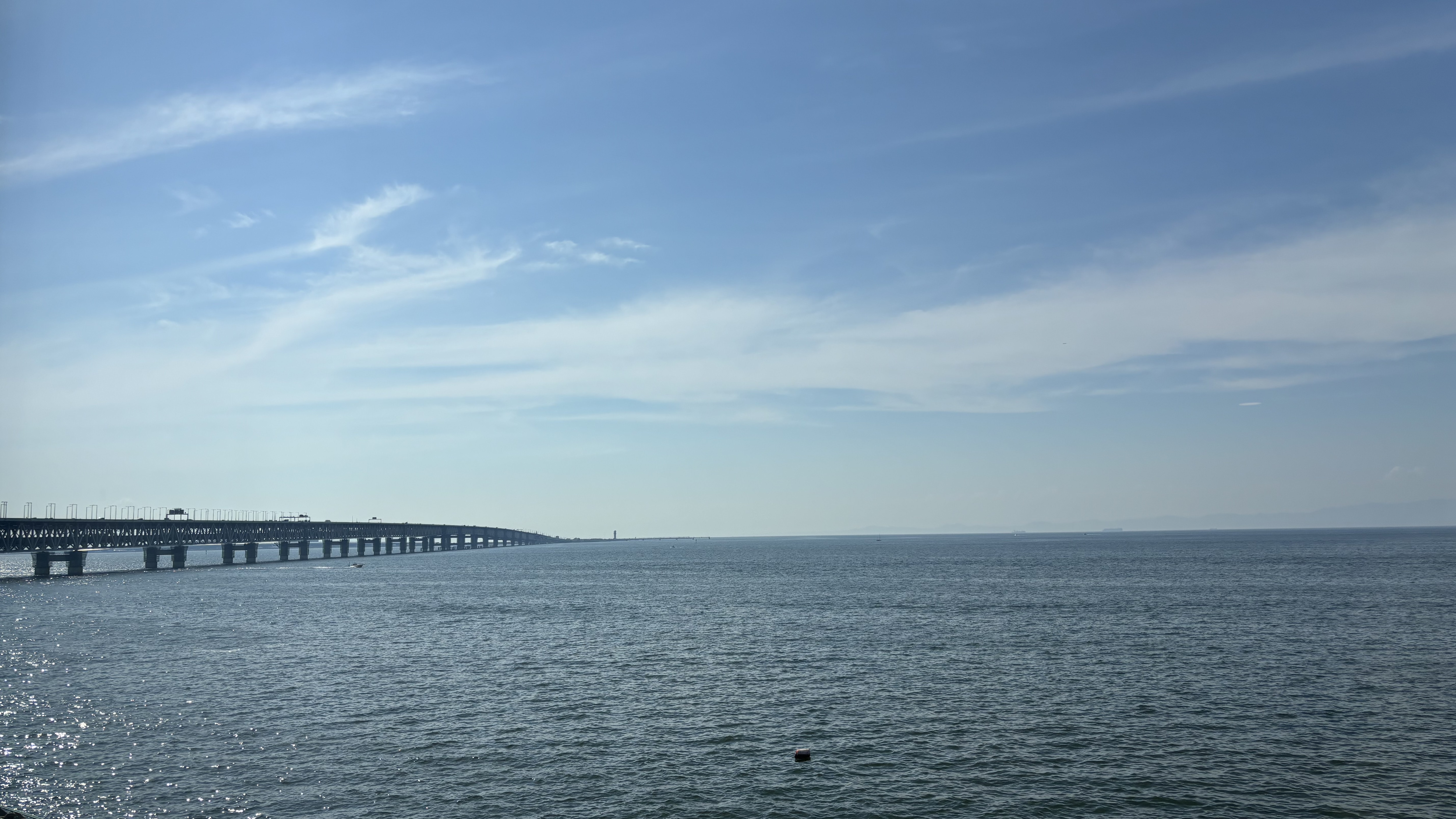 An expansive view of the sea from large windows.