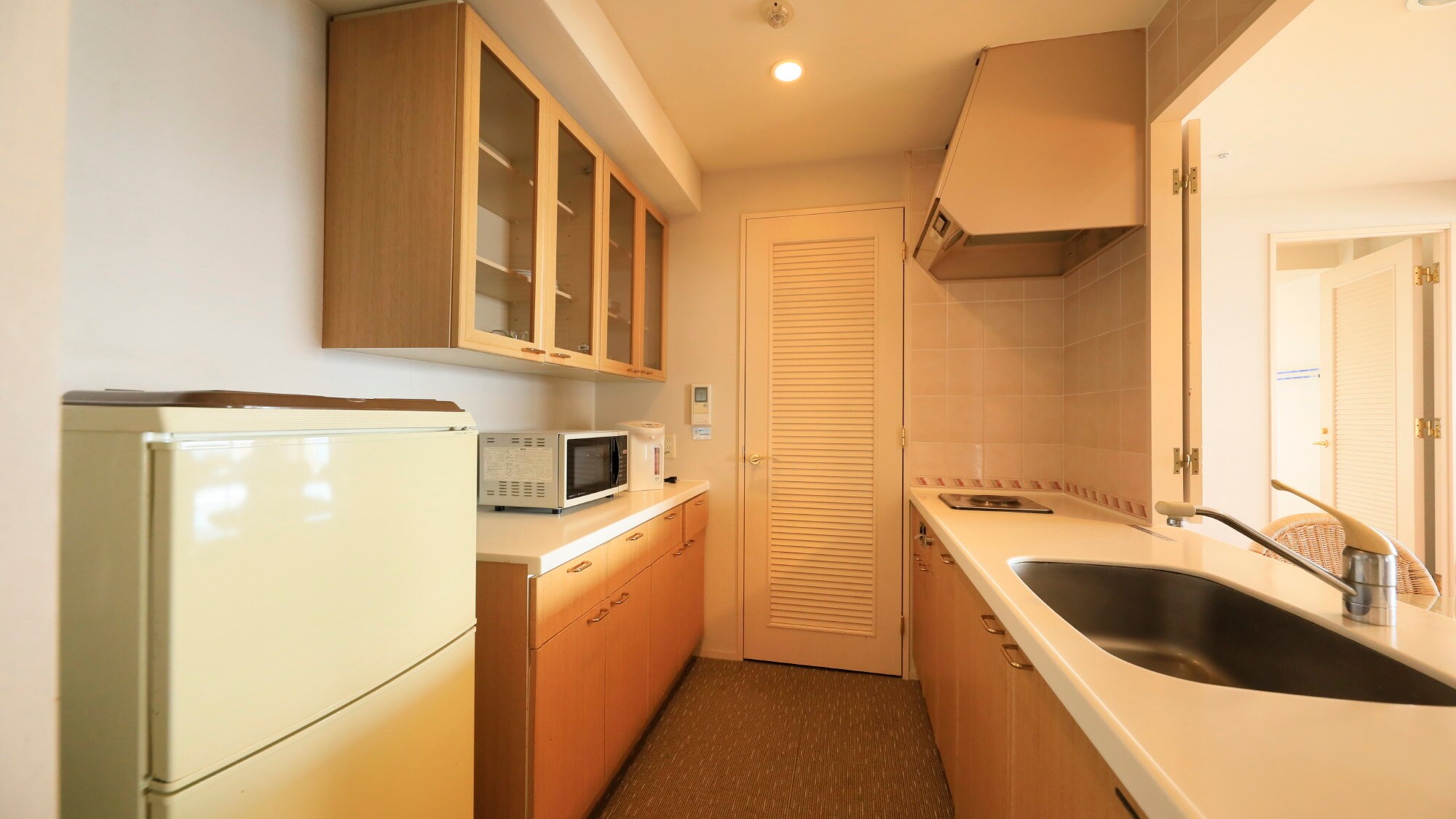 The spacious open kitchen is equipped with a wide range of cooking utensils. *One example