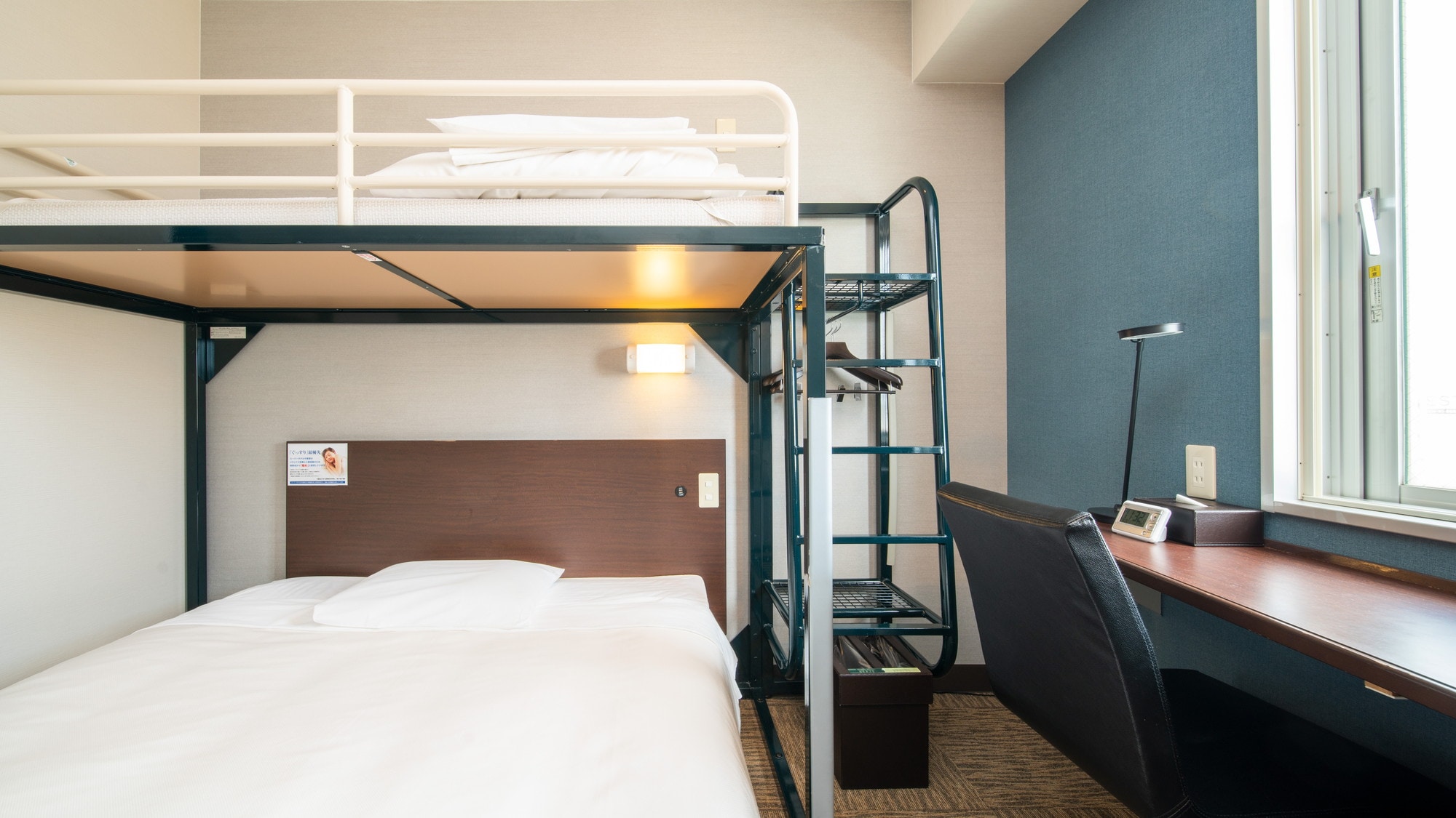 This room has a double bed and a loft bed.