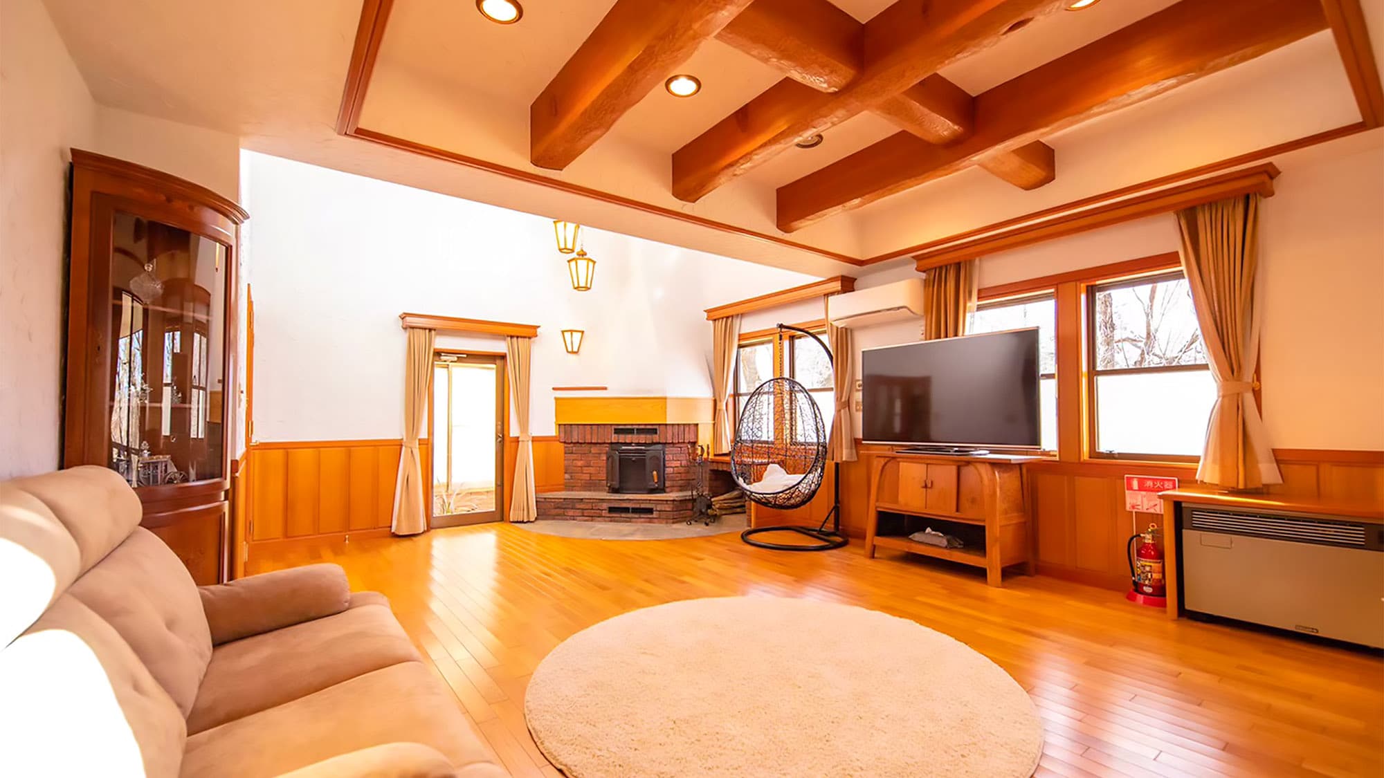 The spacious living room with fireplace creates a relaxing atmosphere.