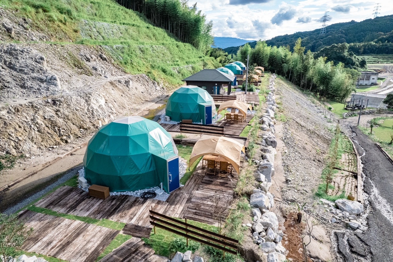 A large dome tent with a cute blue-green exterior