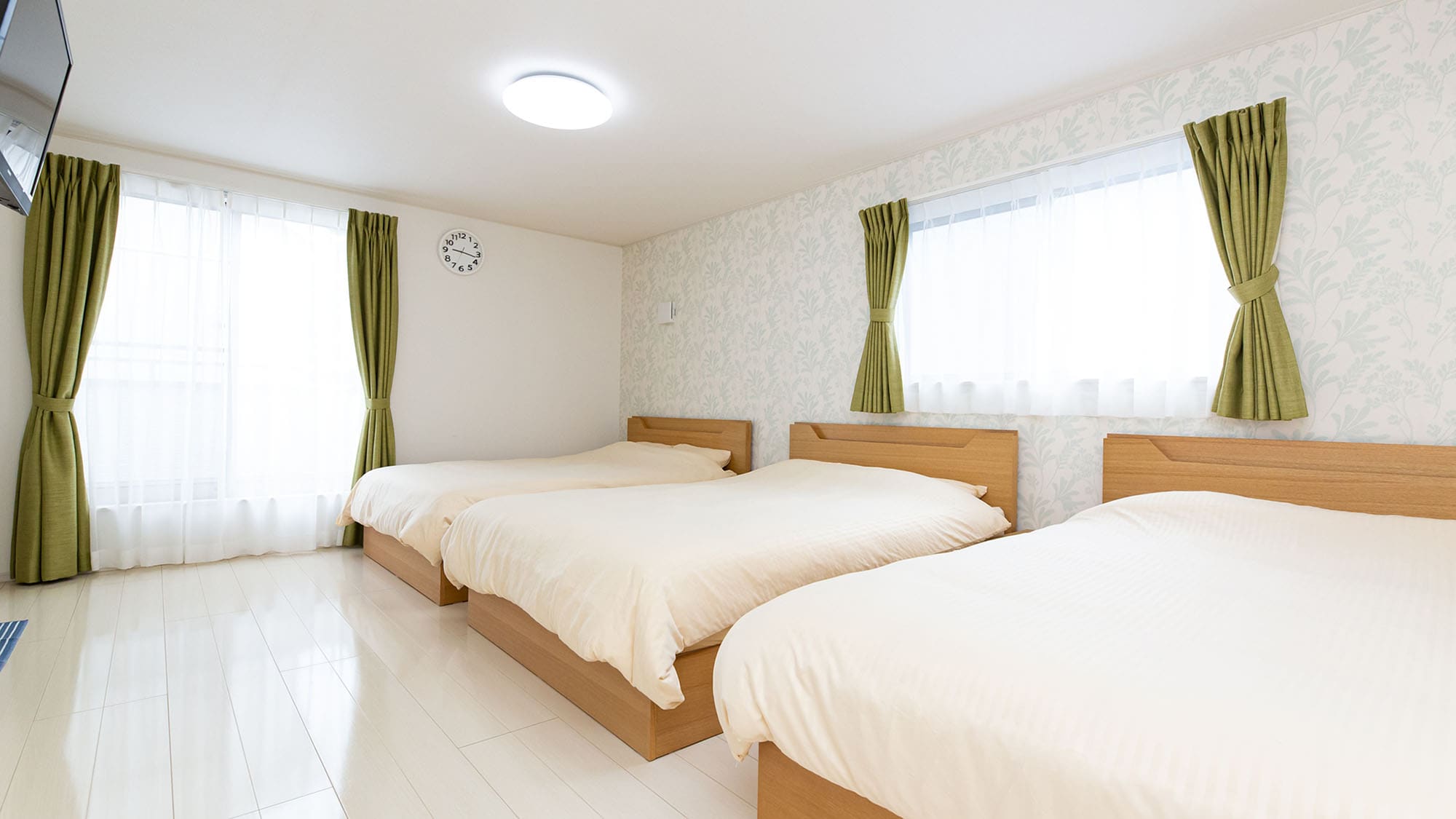 [Building A - Bedroom] A bedroom with three double beds.
