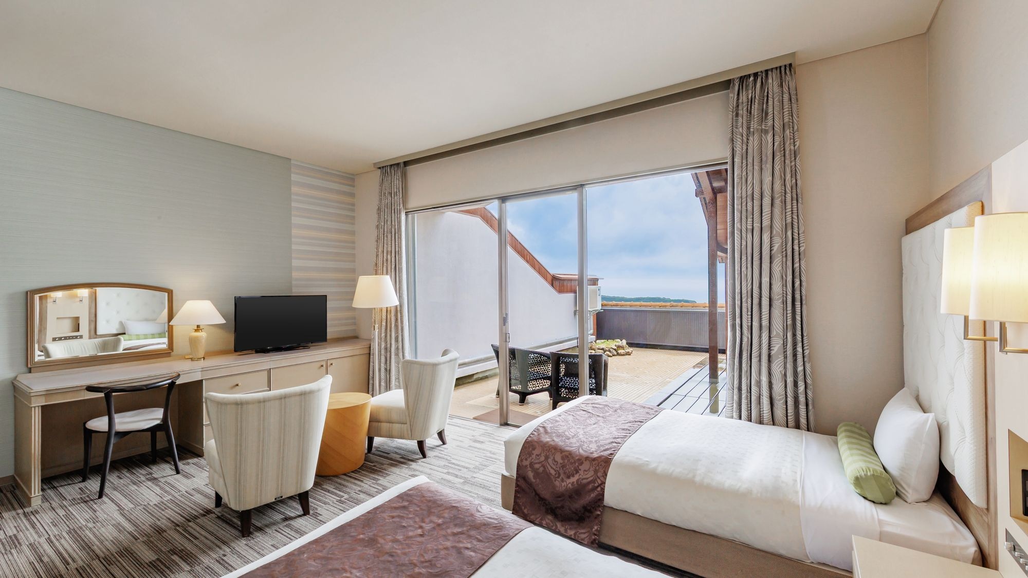 Premium Japanese-Western style room with ocean view and natural open-air hot spring bath.