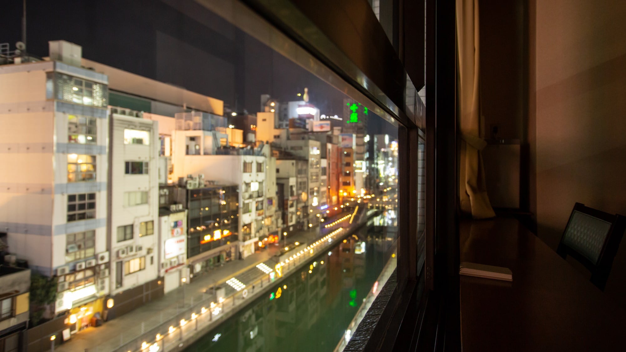 * [View from the room] The contrast between the bustling city of Minami and the quiet room is fresh.