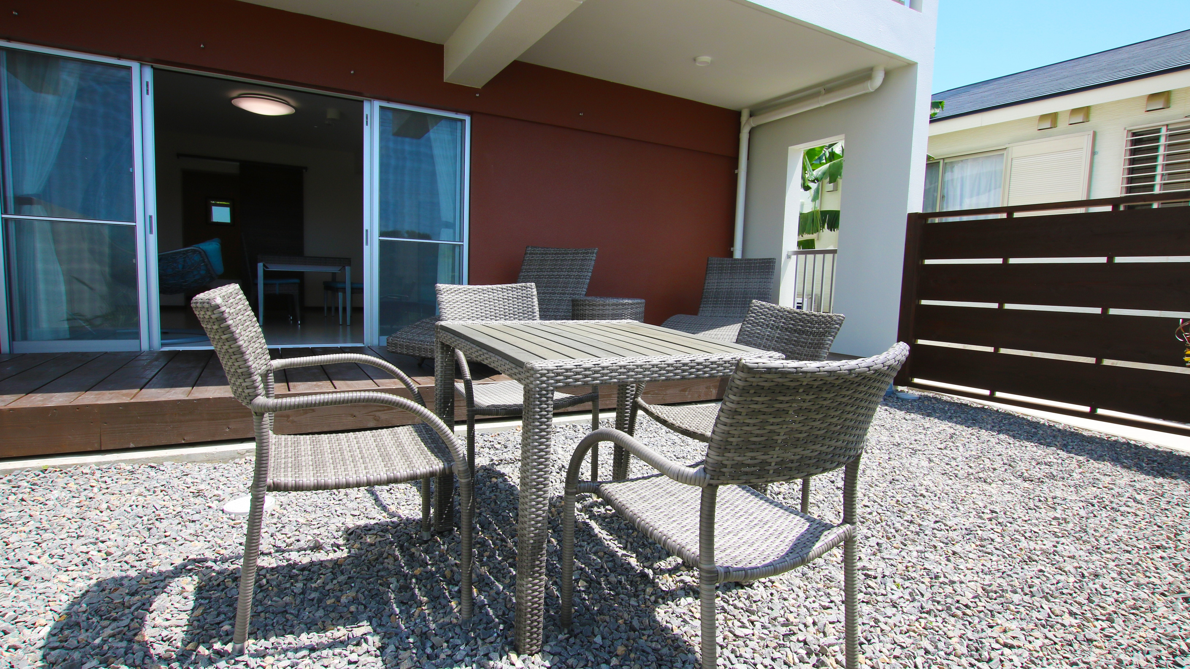 101: A garden space connected to the living room by a wooden deck. BBQ is also available.
