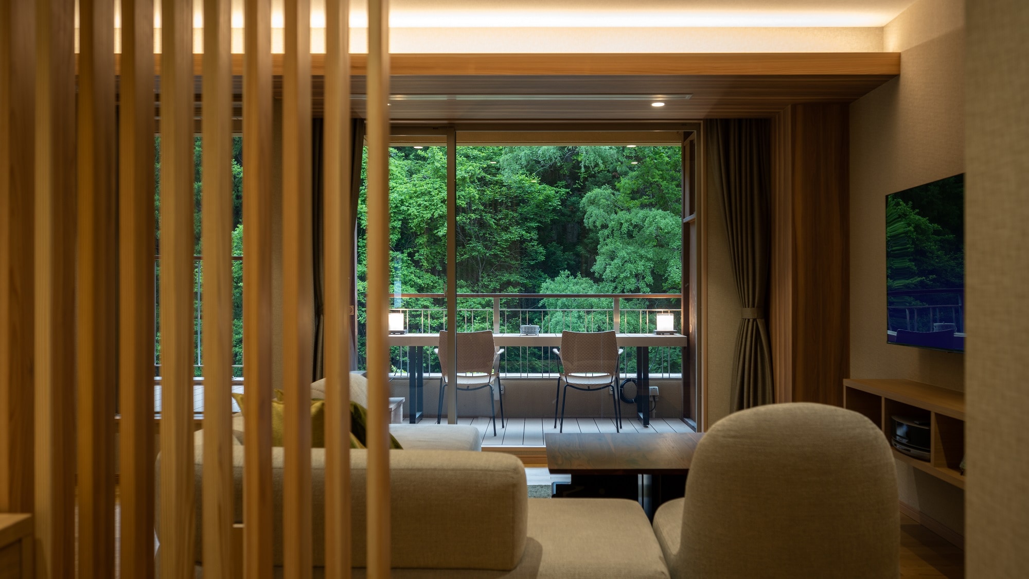 The living room of the Shidate Suite overlooks the Toyosawa River mountain stream and the mountains on the opposite bank.