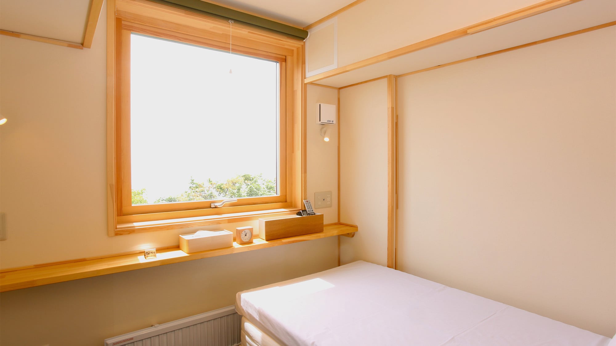 Bright sunlight pours in through the large windows.