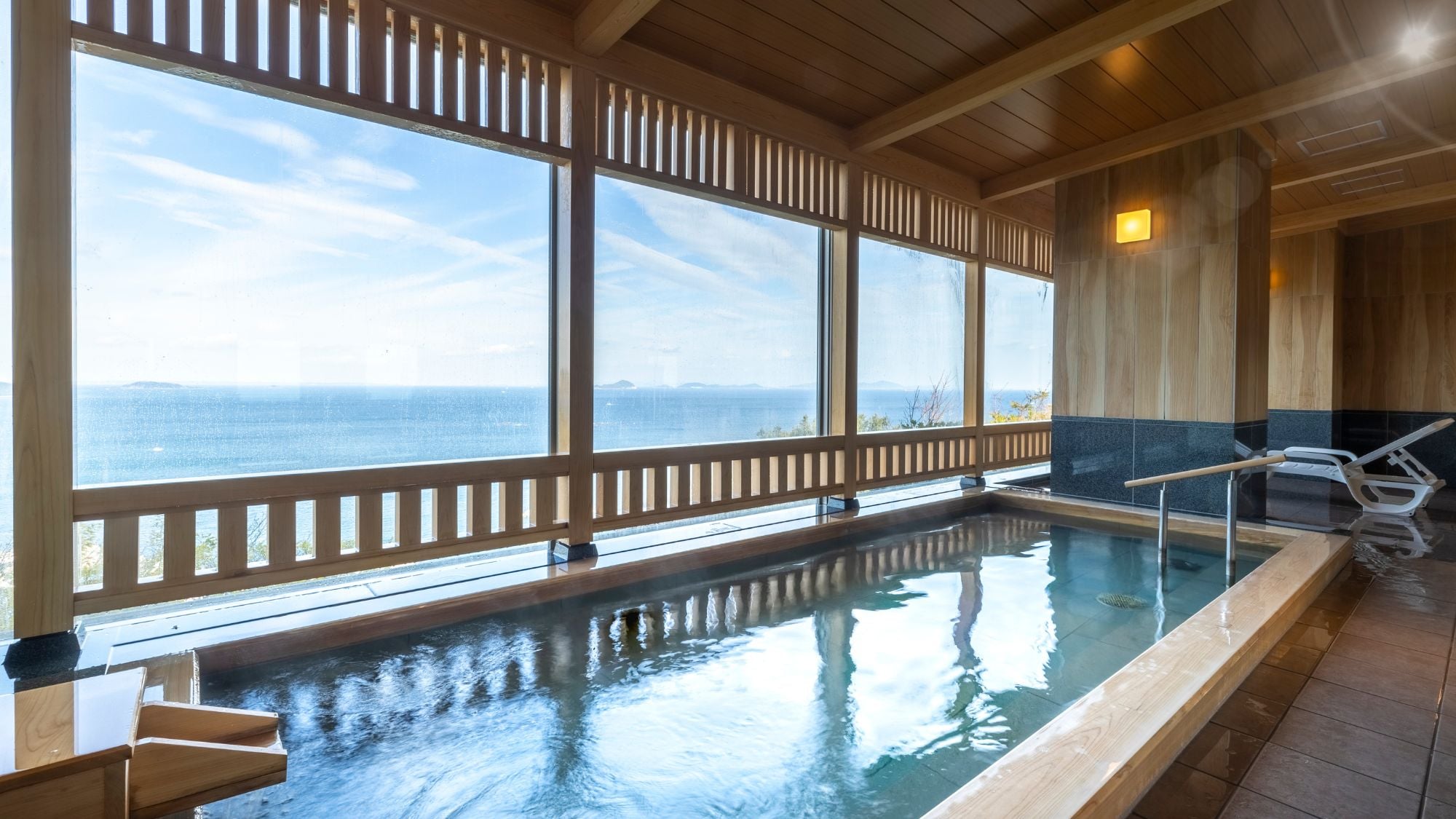 A large hot spring bath with a view overlooking the horizon