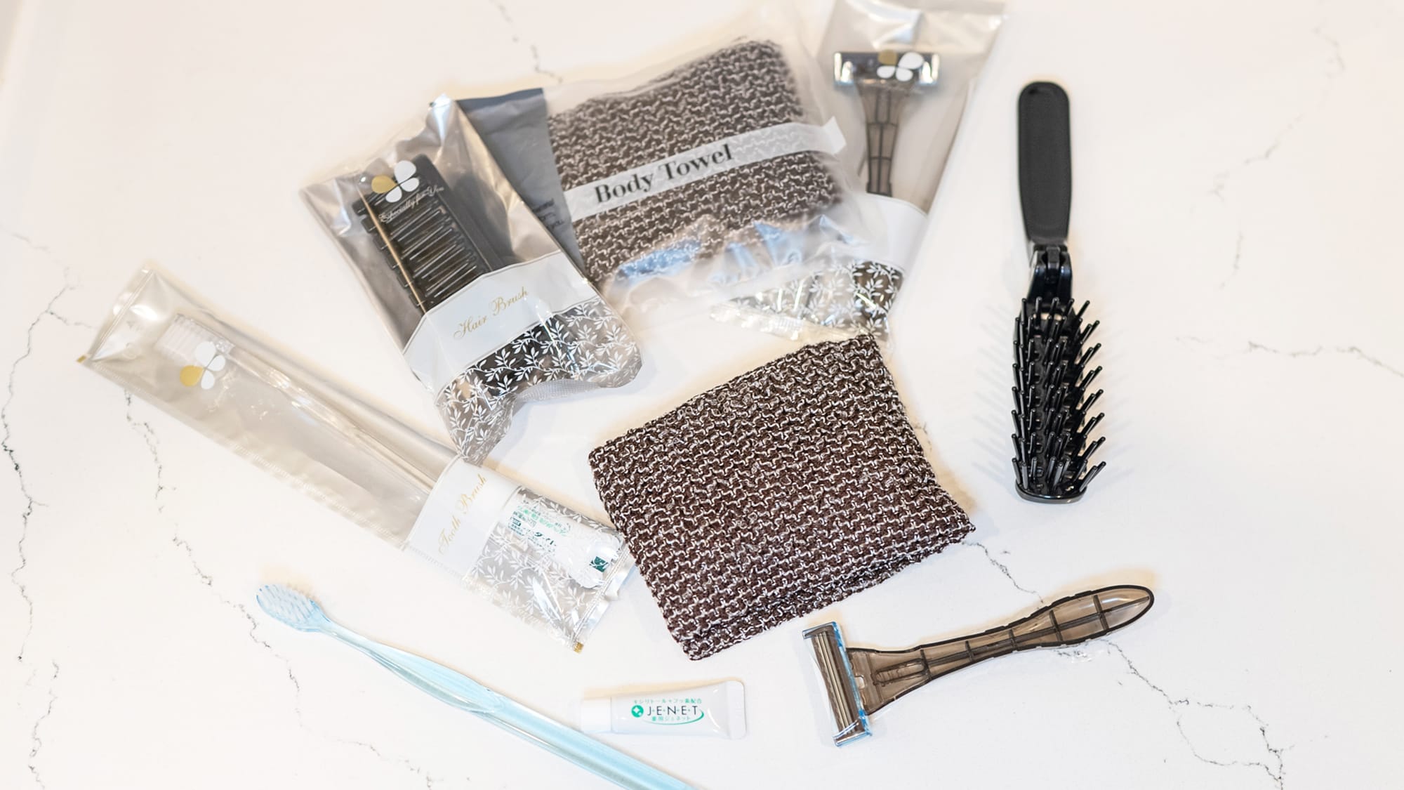 Amenities (toothbrush, body towel, brush, razor, shaving cream, cotton swab)