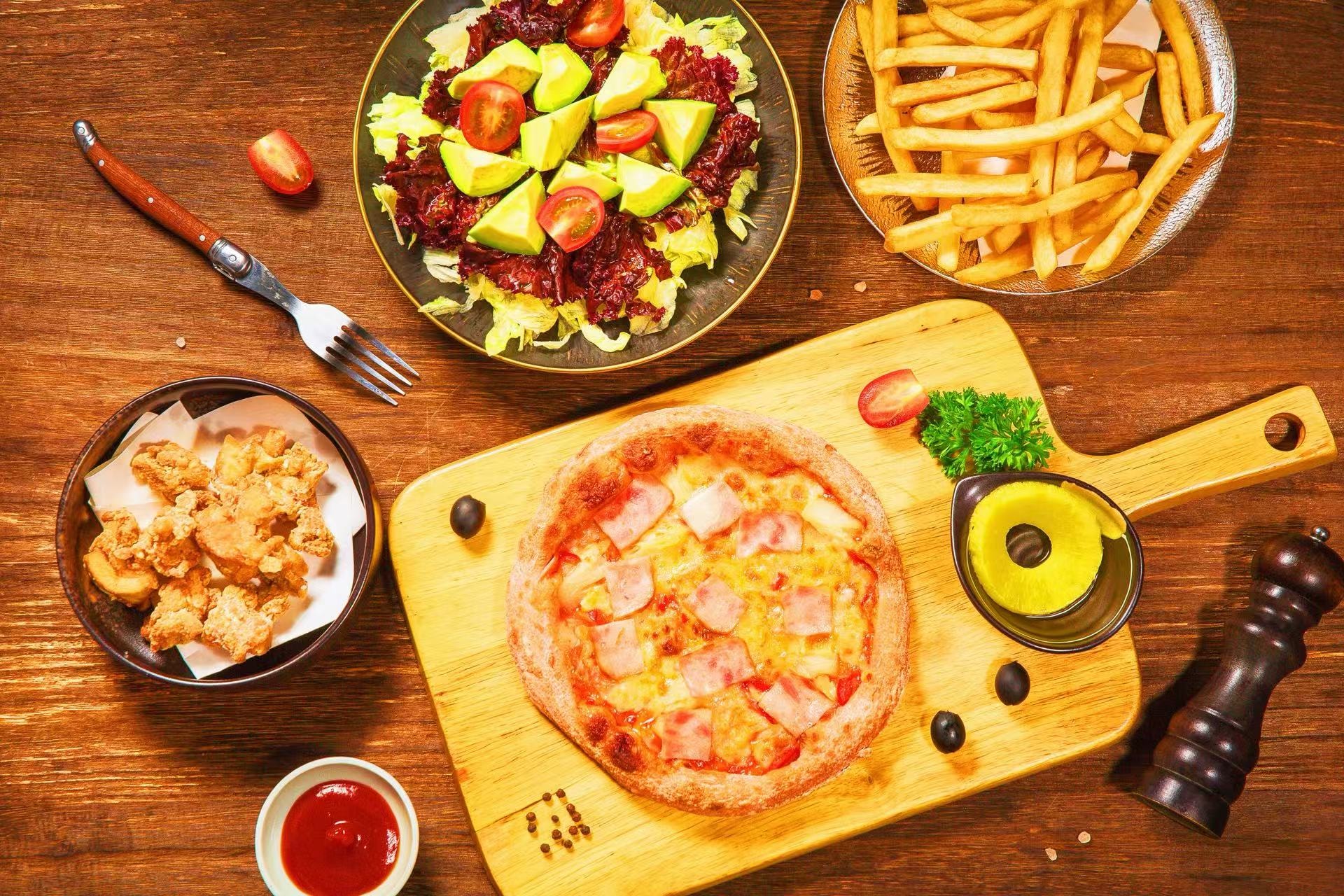 Pizza, french fries, chicken nuggets and vegetable salad set