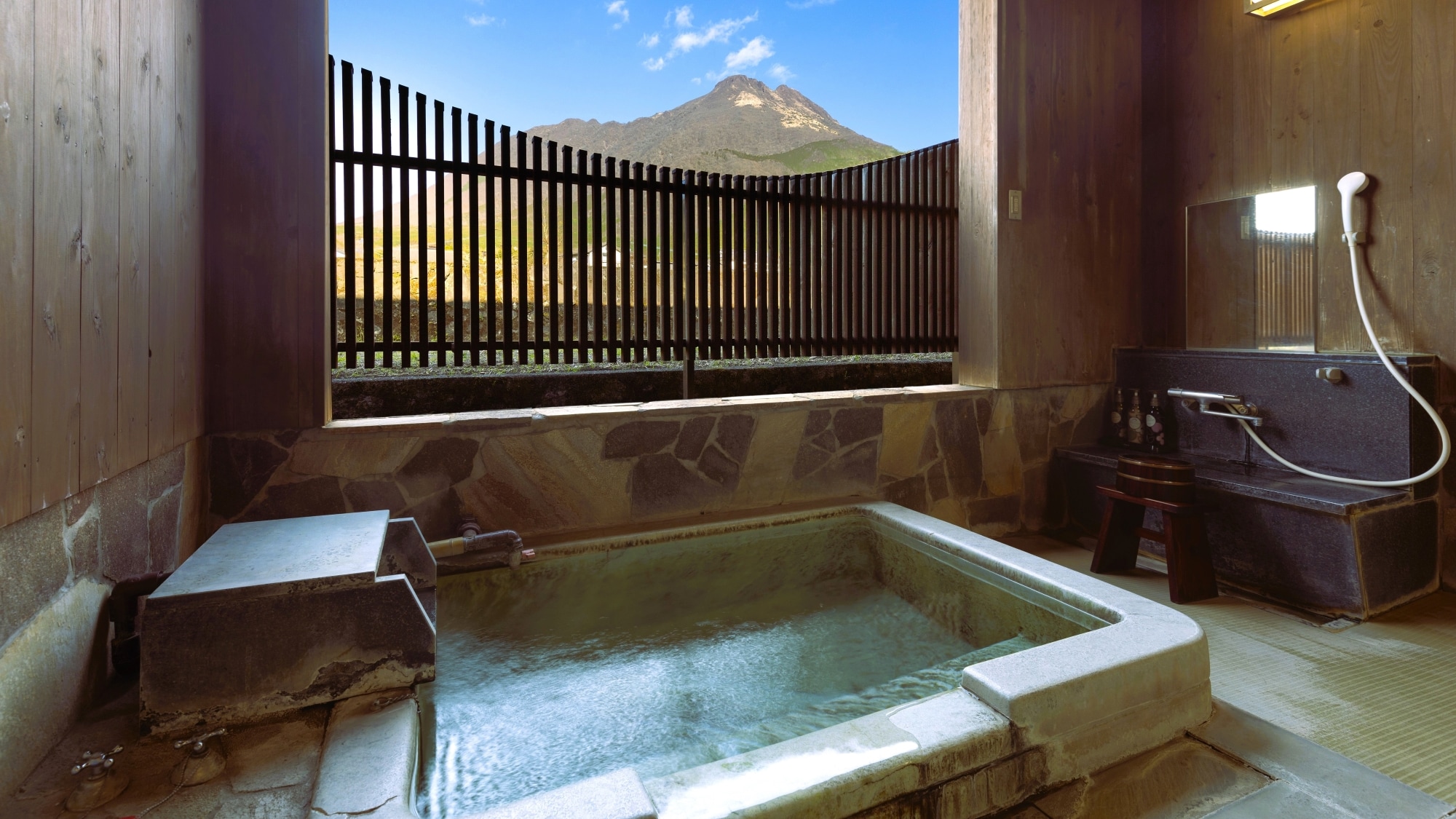 Semi-open-air bath in the guest room overlooking Mt. Yufu