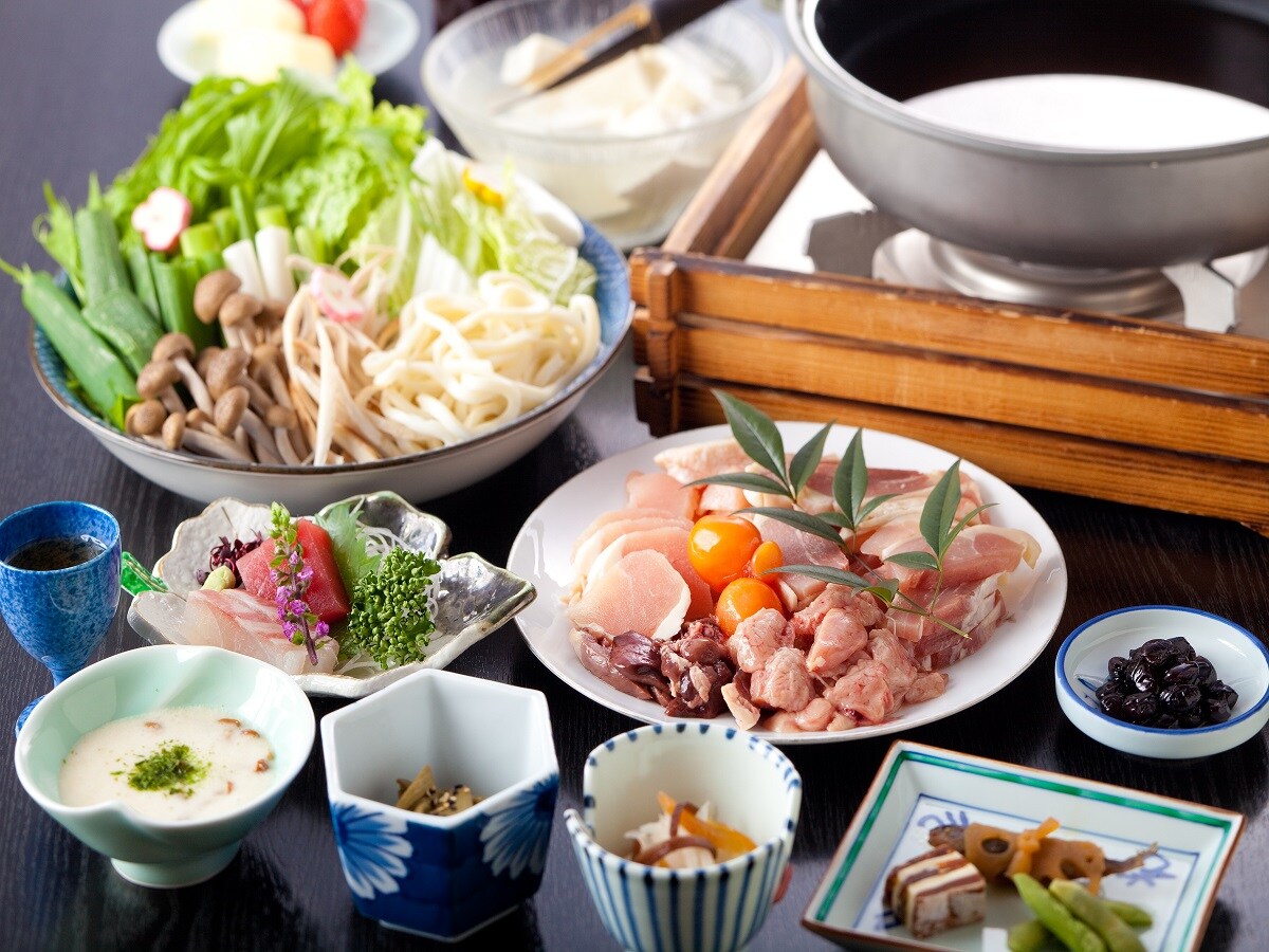 Supper (local chicken hot pot) with plenty of vegetables. The sweetness of vegetables also blends into the soup stock