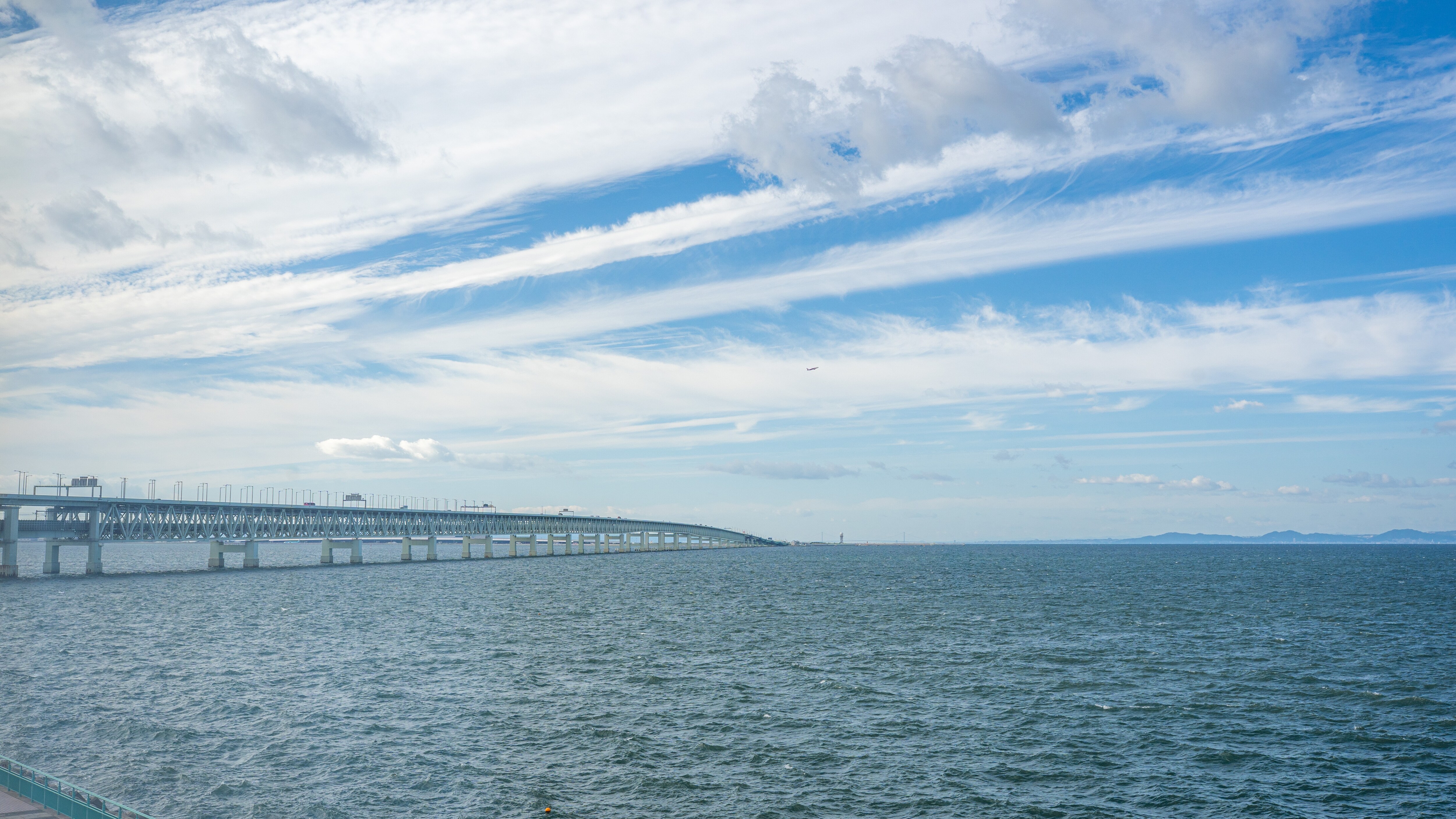 An expansive view of the sea from large windows.