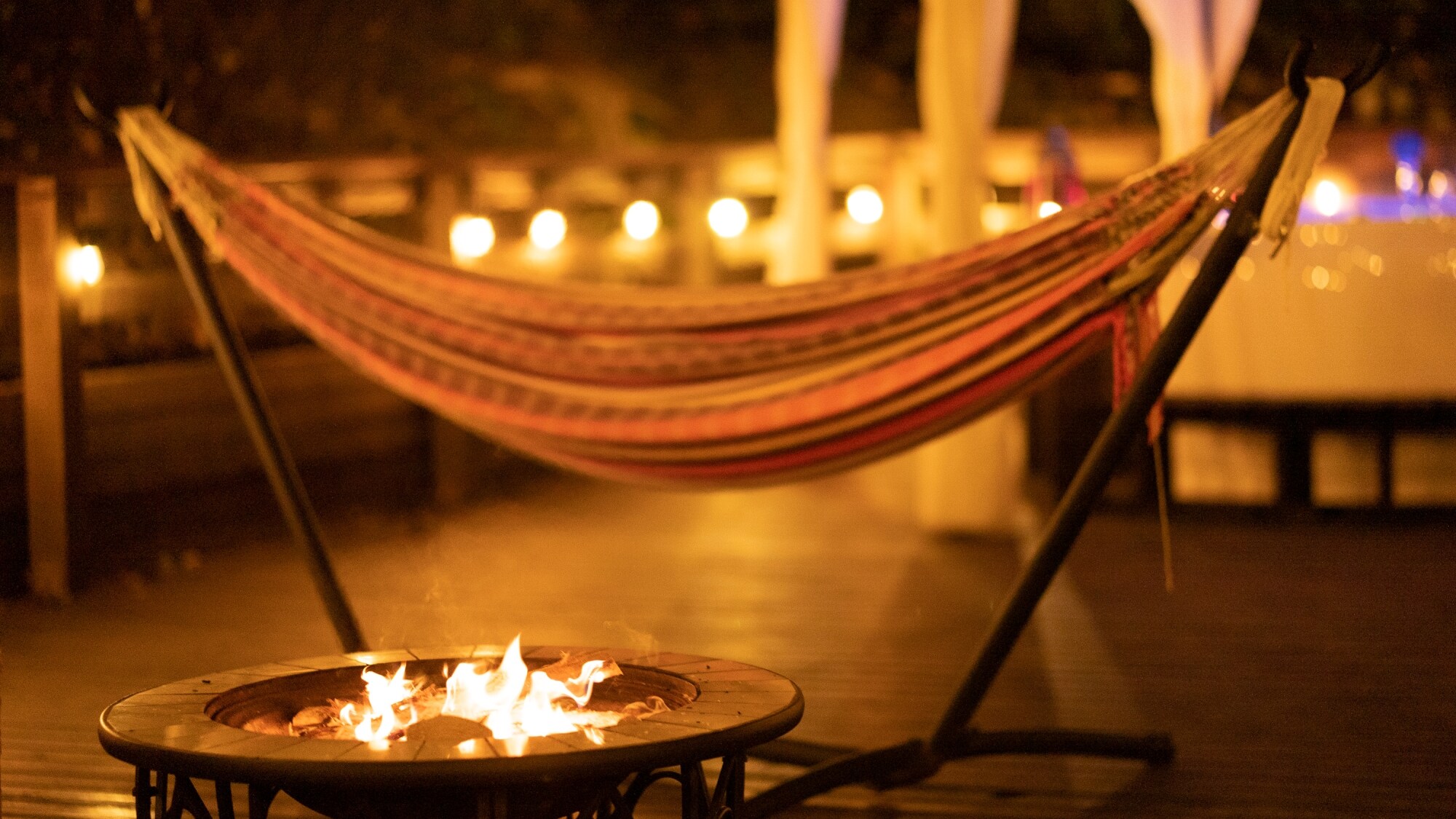 *[SITE_A/Hammock] Tận hưởng thời gian bên đống lửa trại trong khi thư giãn với chiếc võng đung đưa thoải mái.