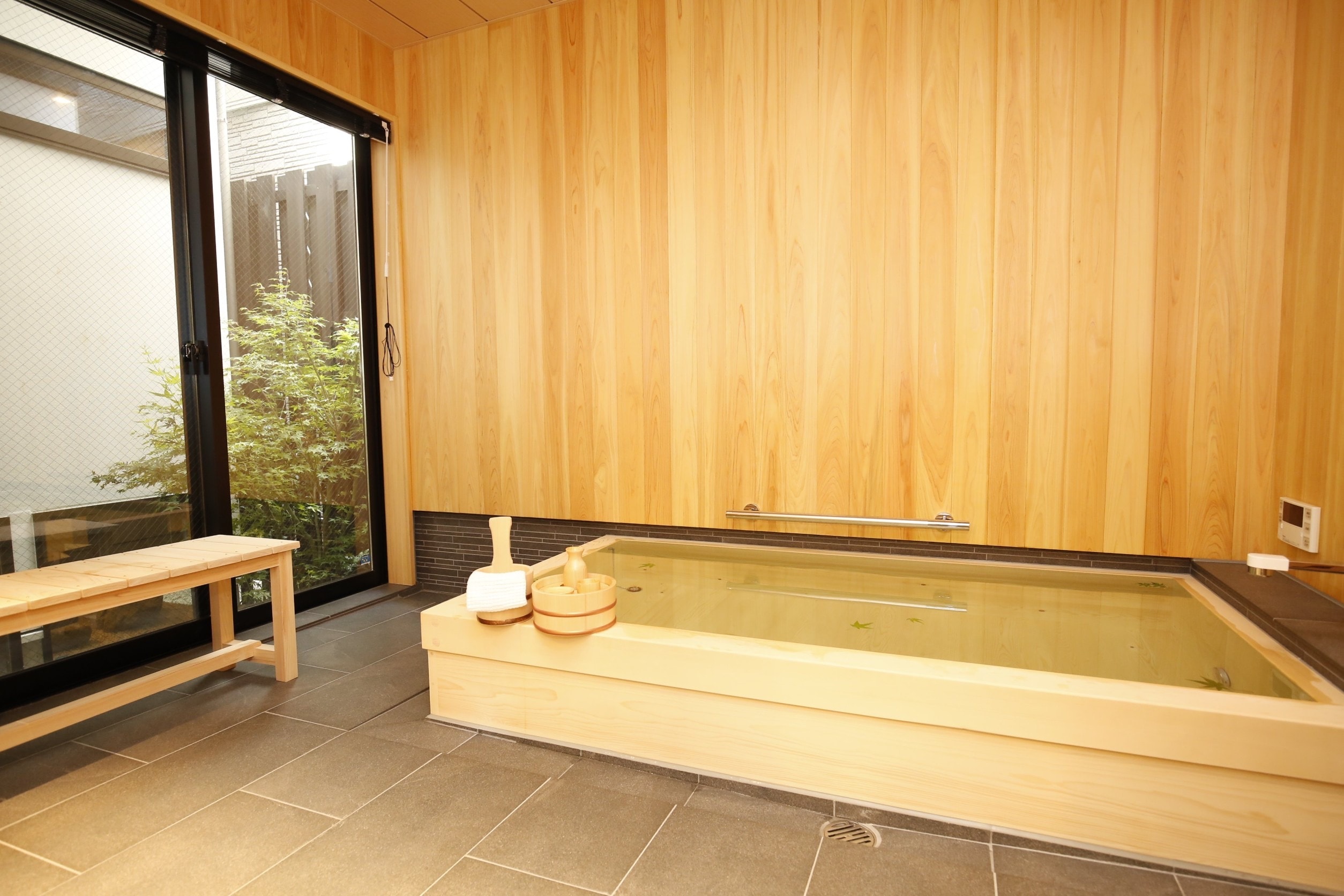 The spacious bathroom has a cypress bathtub